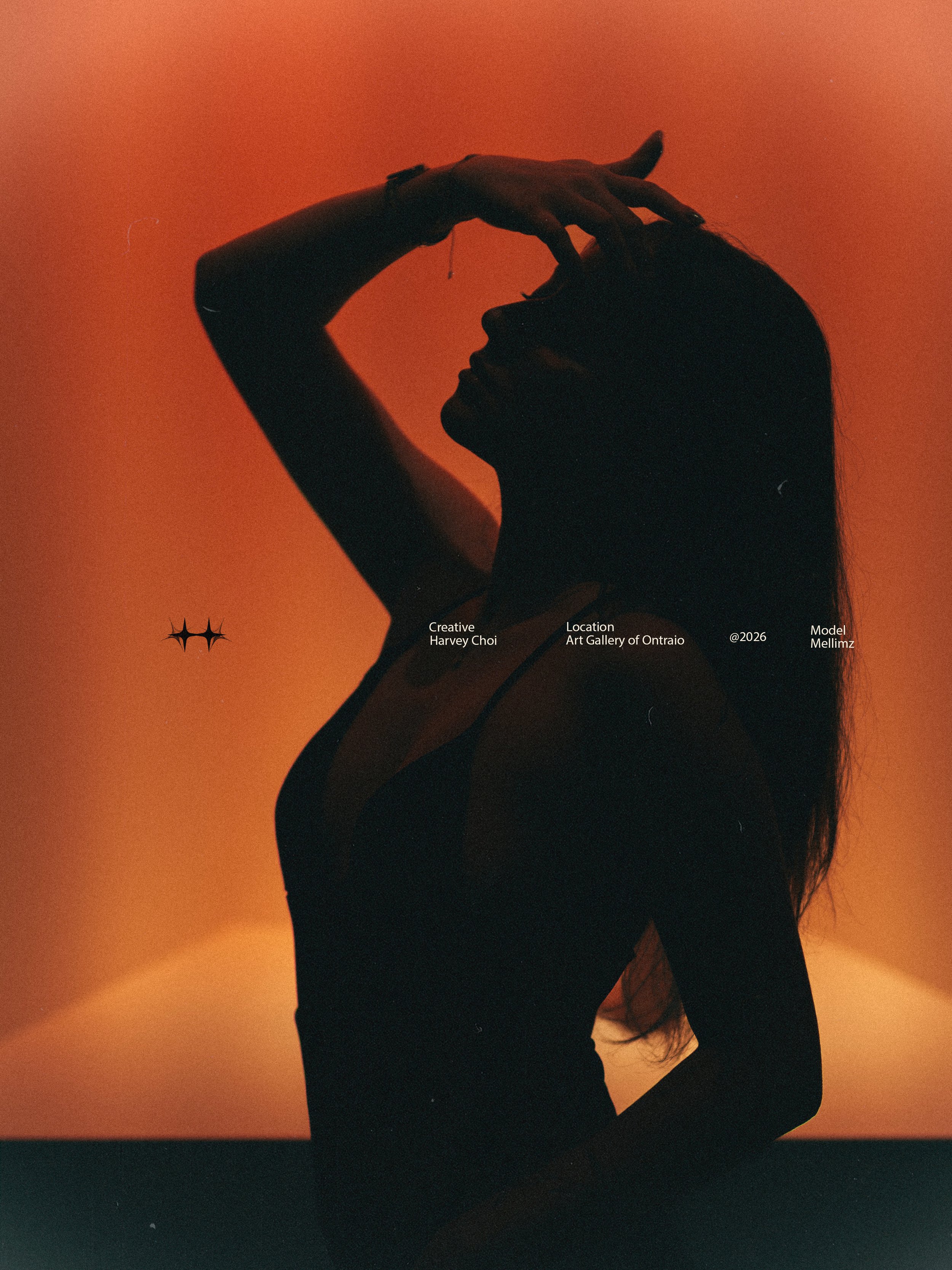 Silhouette of a woman with long hair against an orange background, with her hand resting on her forehead.