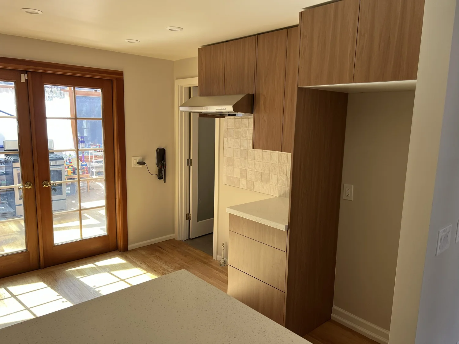 Modern kitchen remodel with walnut-tone cabinets and stainless appliances