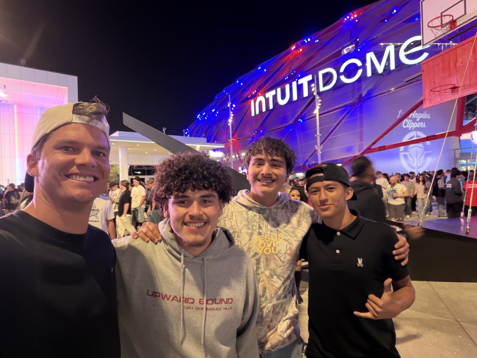 Forge founder with three young men outside Intuit Dome during a basketball outing.