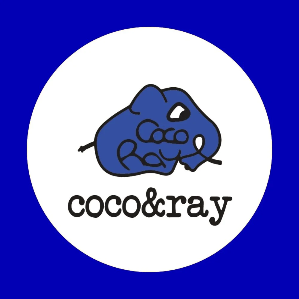 Logo featuring a blue rock with the words 'coco & ray' written within it, and the text 'coco & ray' below in black.