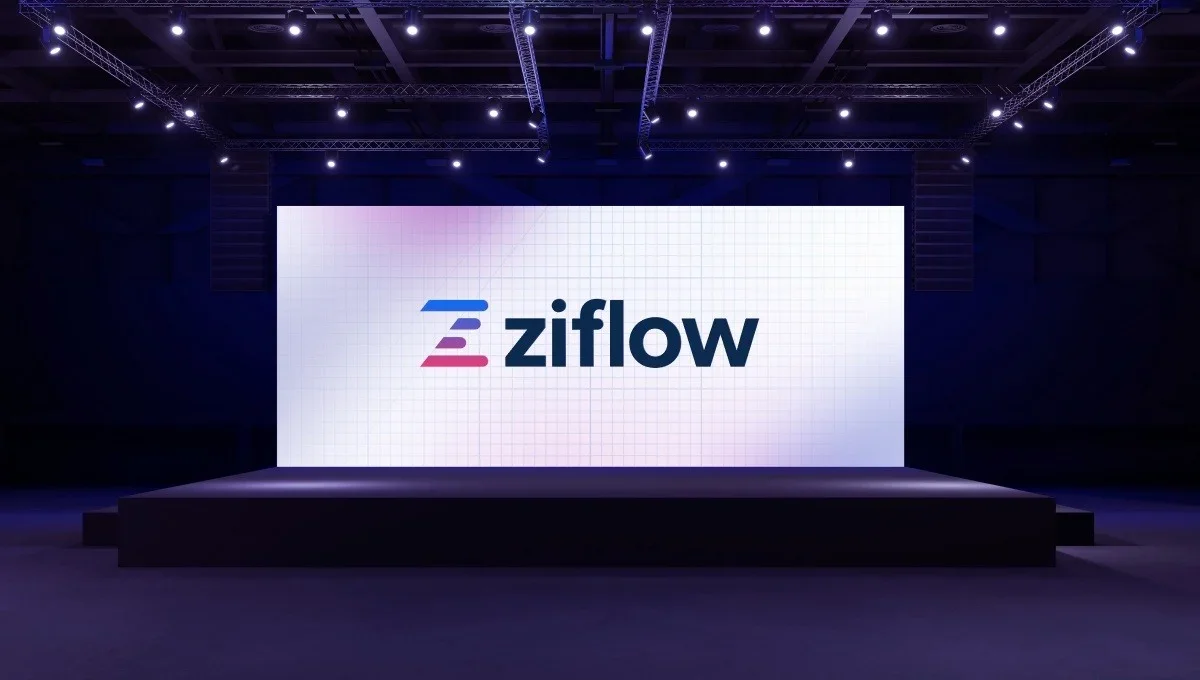 Large stage with a digital screen displaying the logo for Ziflow, a cloud-based collaboration tool, in a dark auditorium.