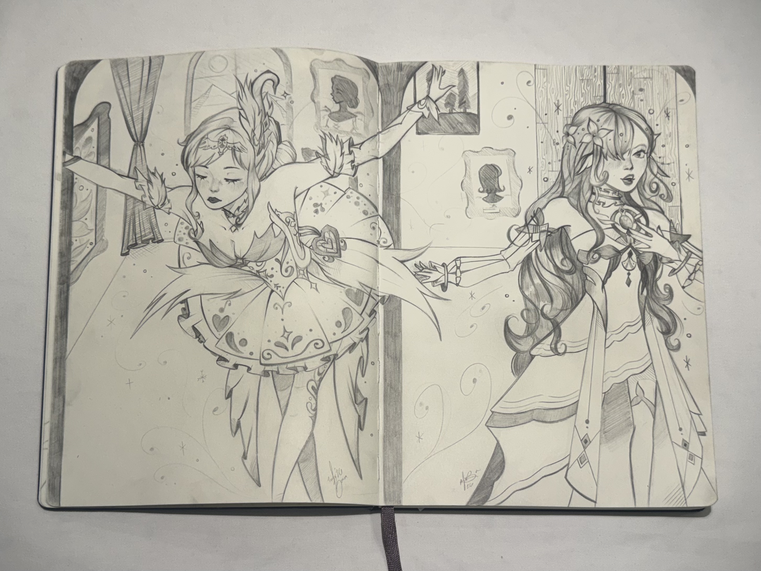 Black and white sketch of fantasy characters, one female with floral hair and another with a moon and star motif, in a detailed scene with framed portraits and decorative patterns.