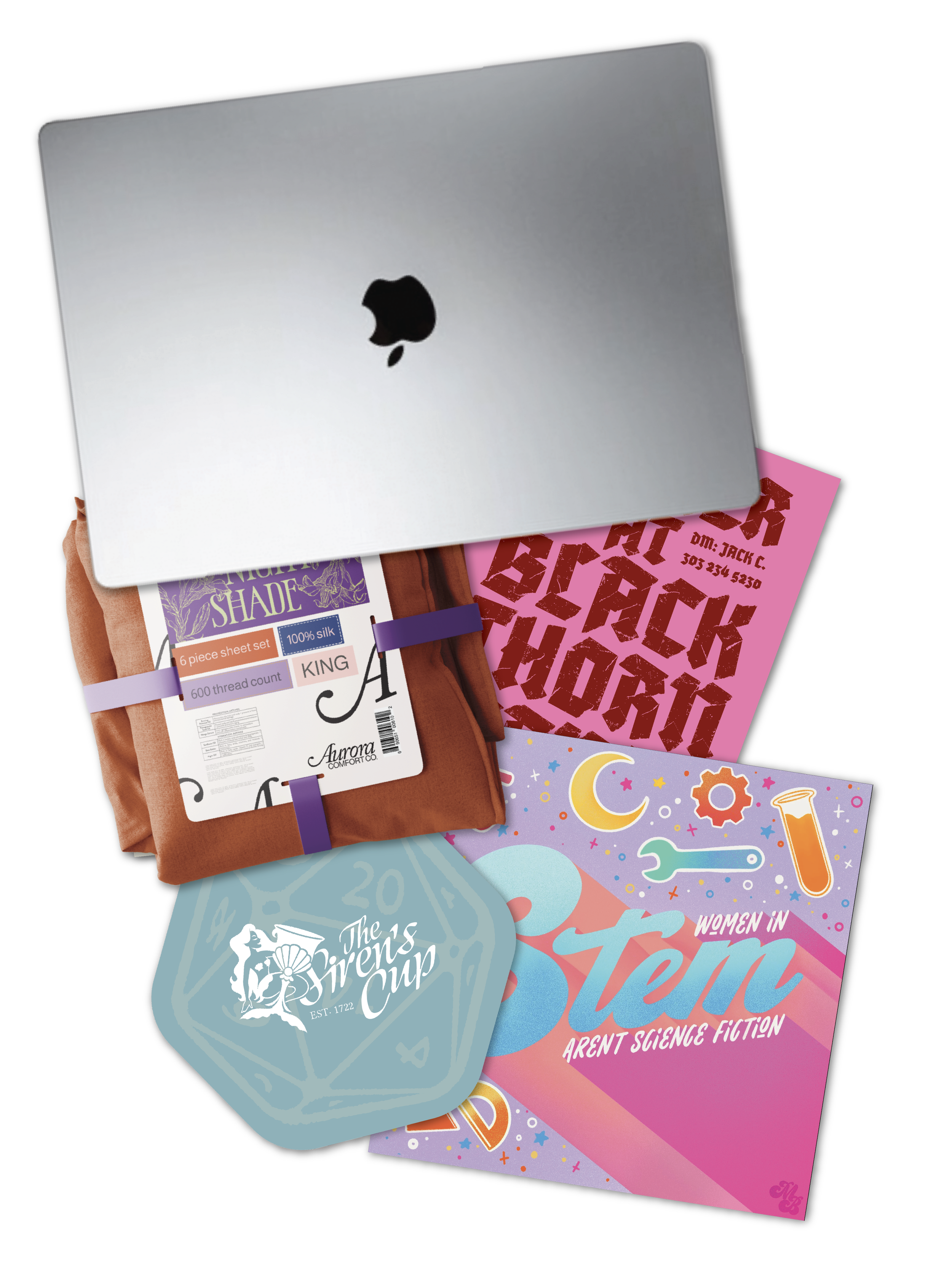 Various colorful books and notebooks arranged on a surface, including titles about science fiction, women's interests, and a sewing set, with a laptop partially covering some of the books.