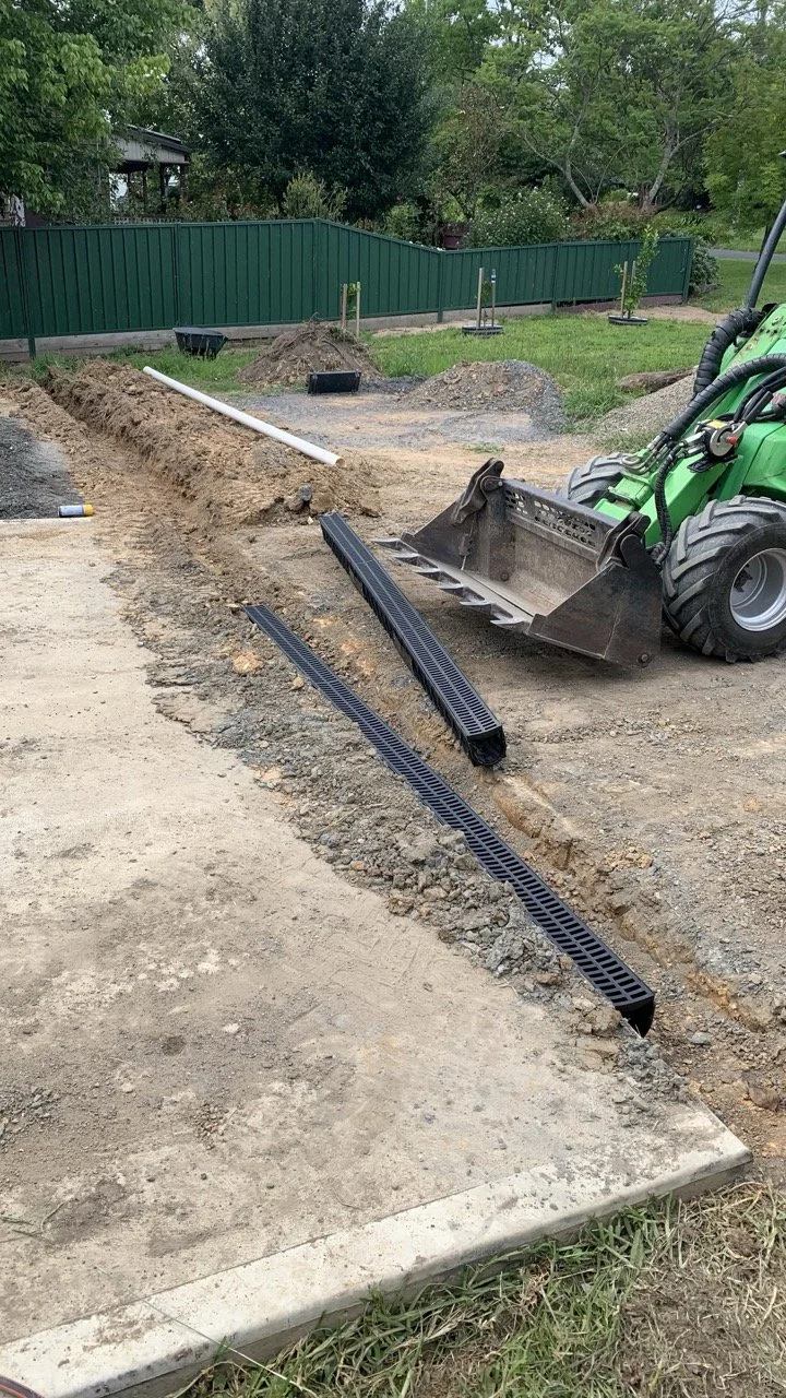 channel draine put it with pvc pipe and green avant loader in the background