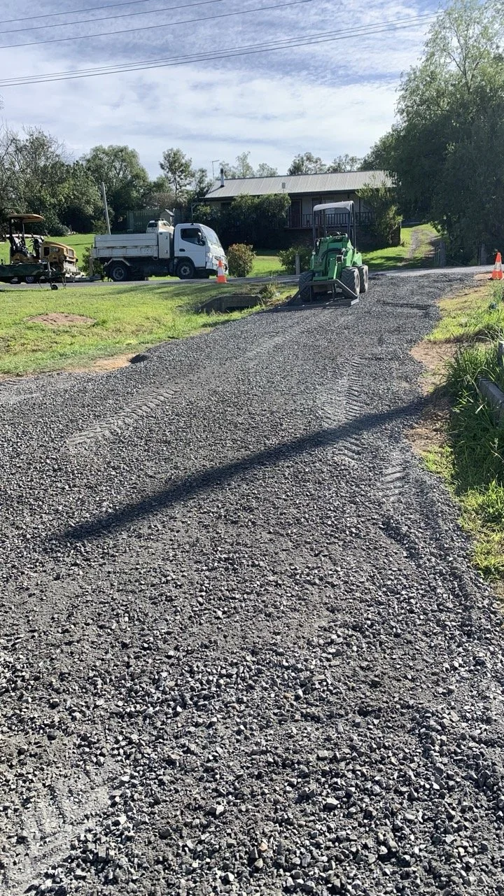 Driveway road base with green Avant loader spreading the road base