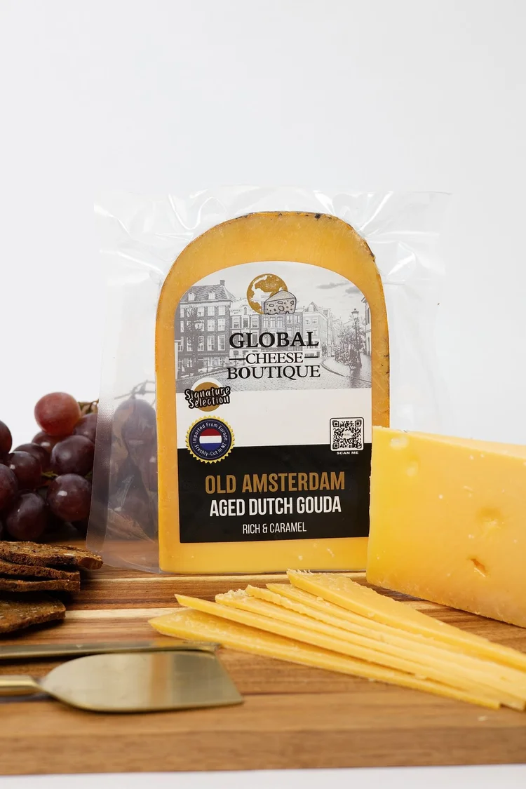 Old Amsterdam Aged Gouda 250 g, sealed pack with a wedge and slices on a wooden board
