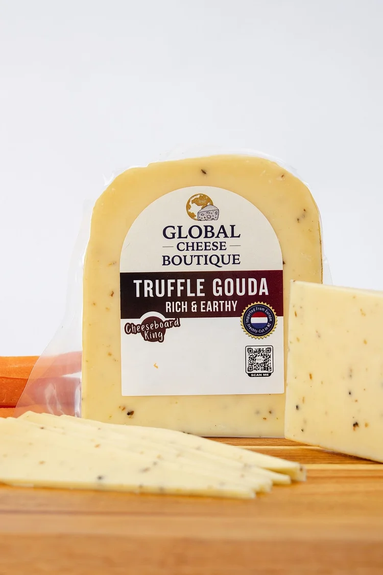 Truffle Gouda pack with a wedge and slices on a wooden board