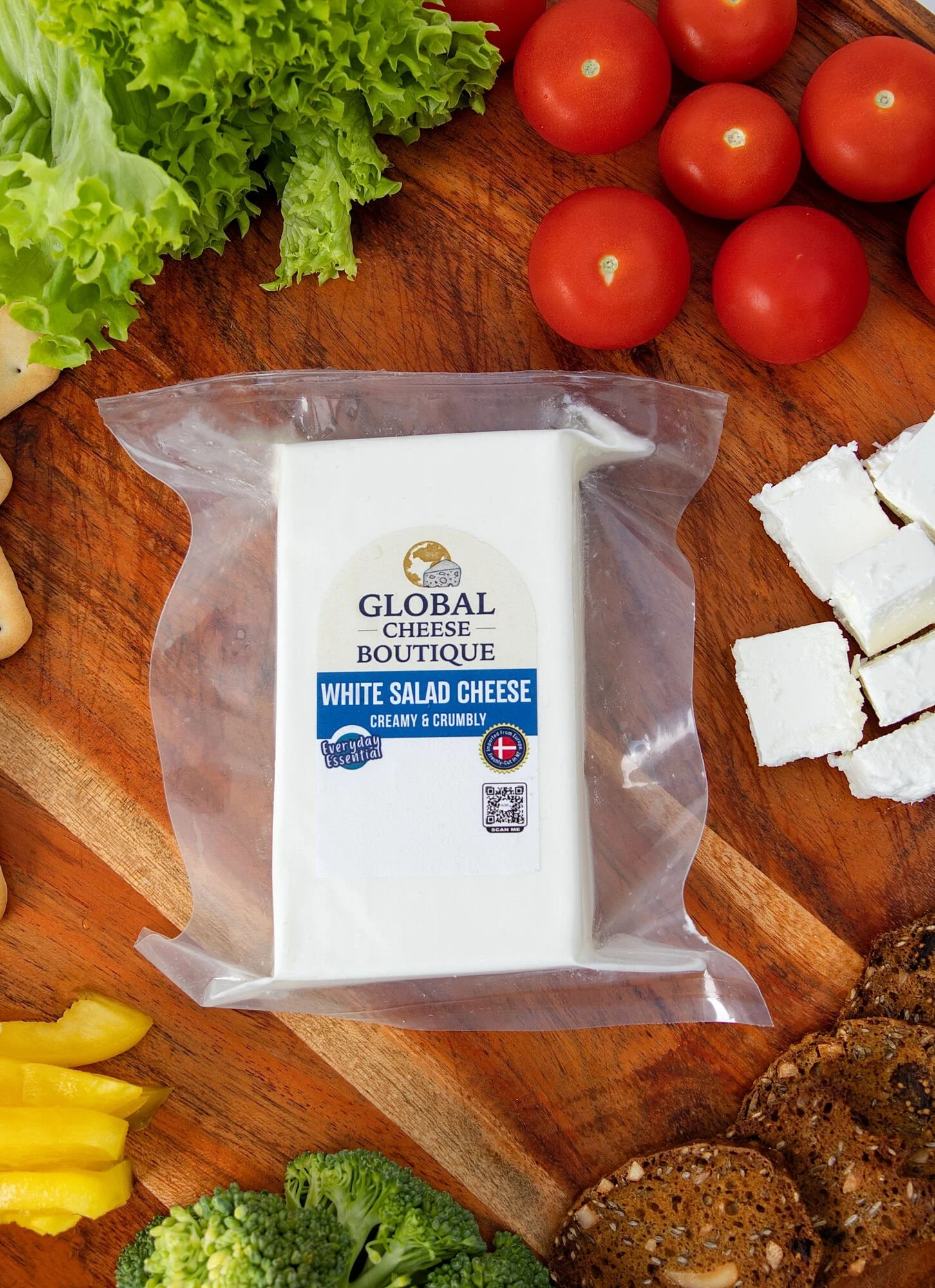 Close-up from above of White Salad Cheese 230 g with cheese cubes and cherry tomatoes