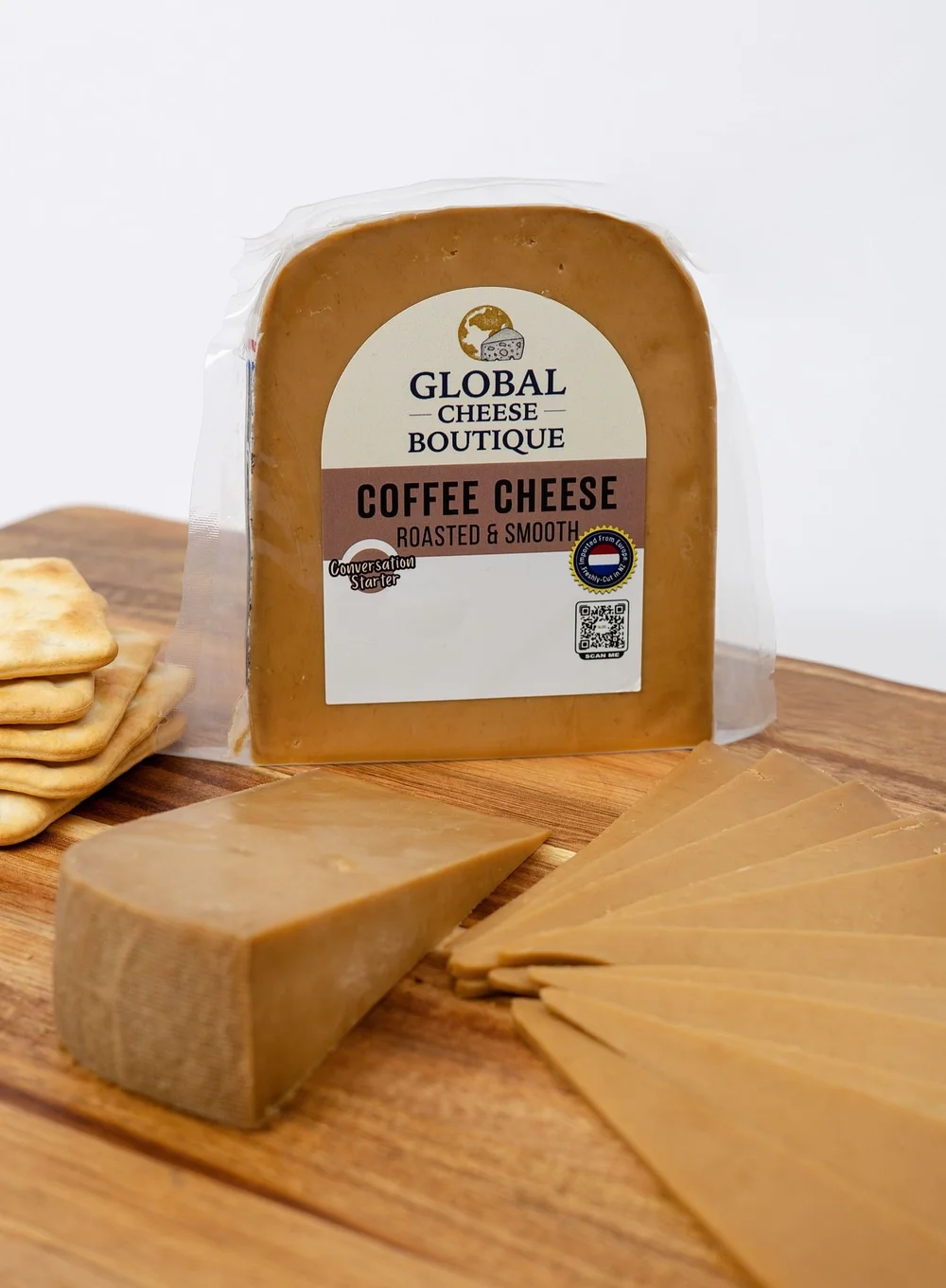 Coffee Gouda pack, wedge and slices with crackers on a wooden board