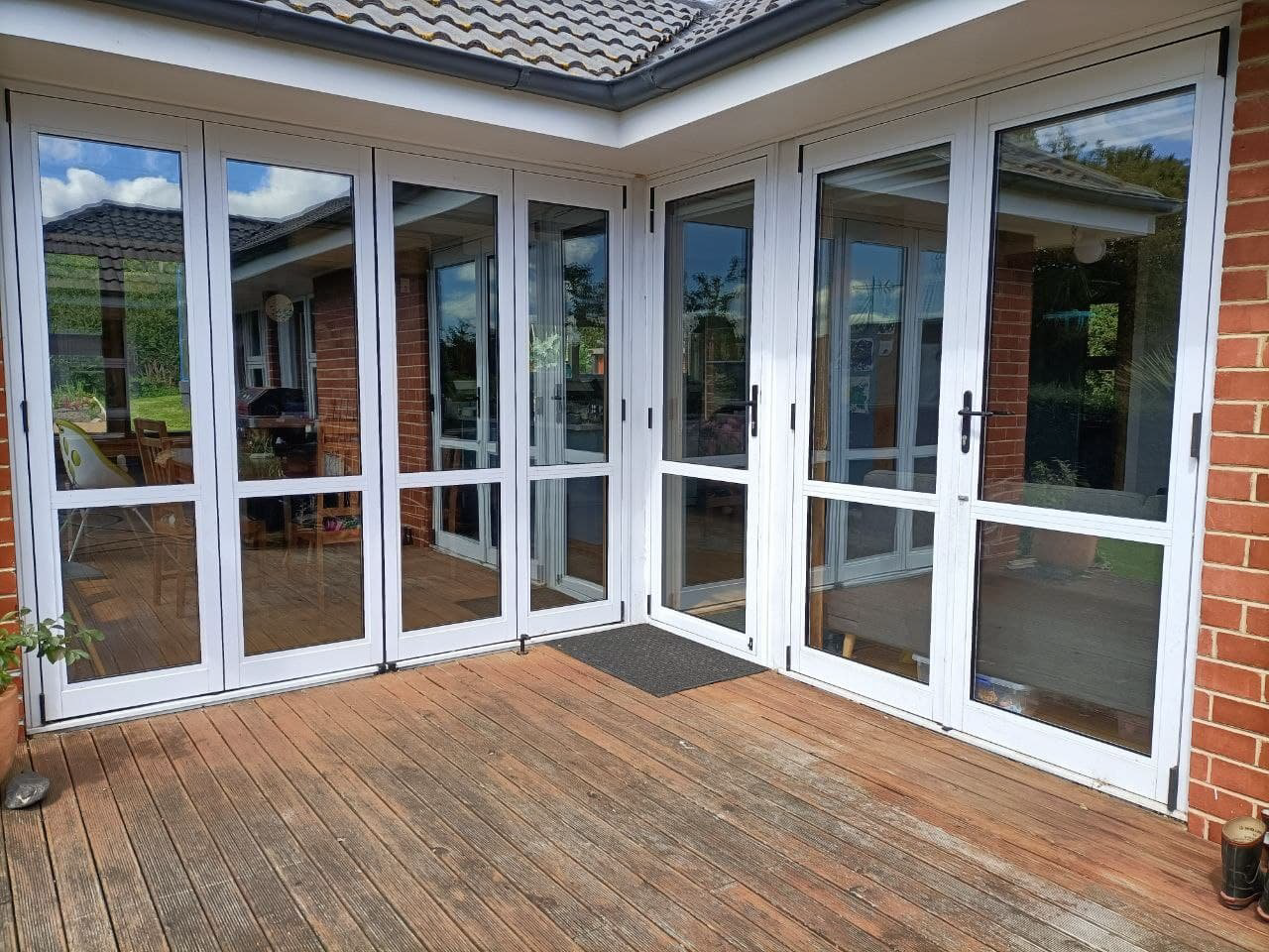 Retrofit double-glazed glass doors leading to the deck of a residential home.