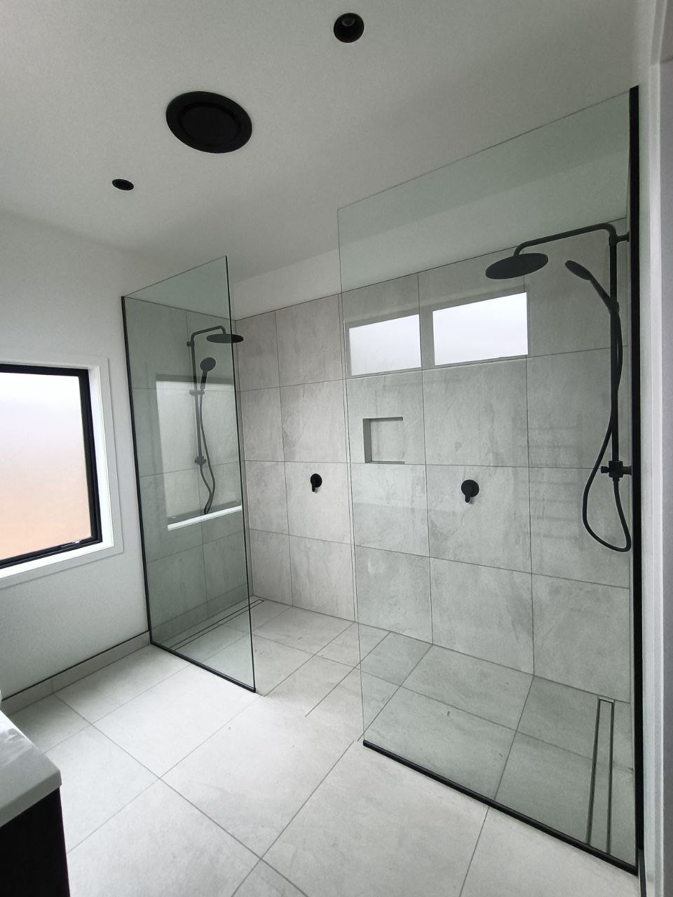 Custom glass shower in a sleek modern home bathroom.
