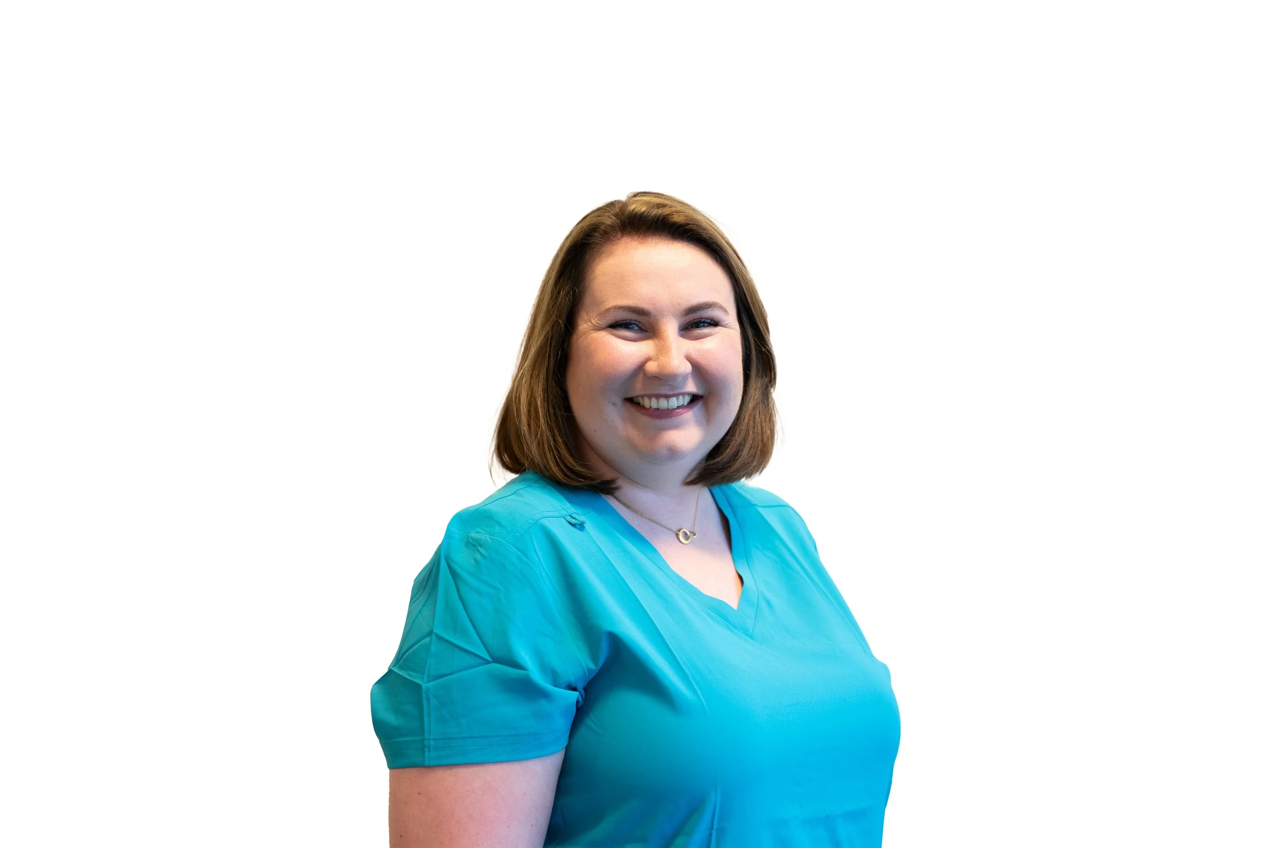 A woman with shoulder-length brown hair smiling, wearing a blue scrub top, against a white background.