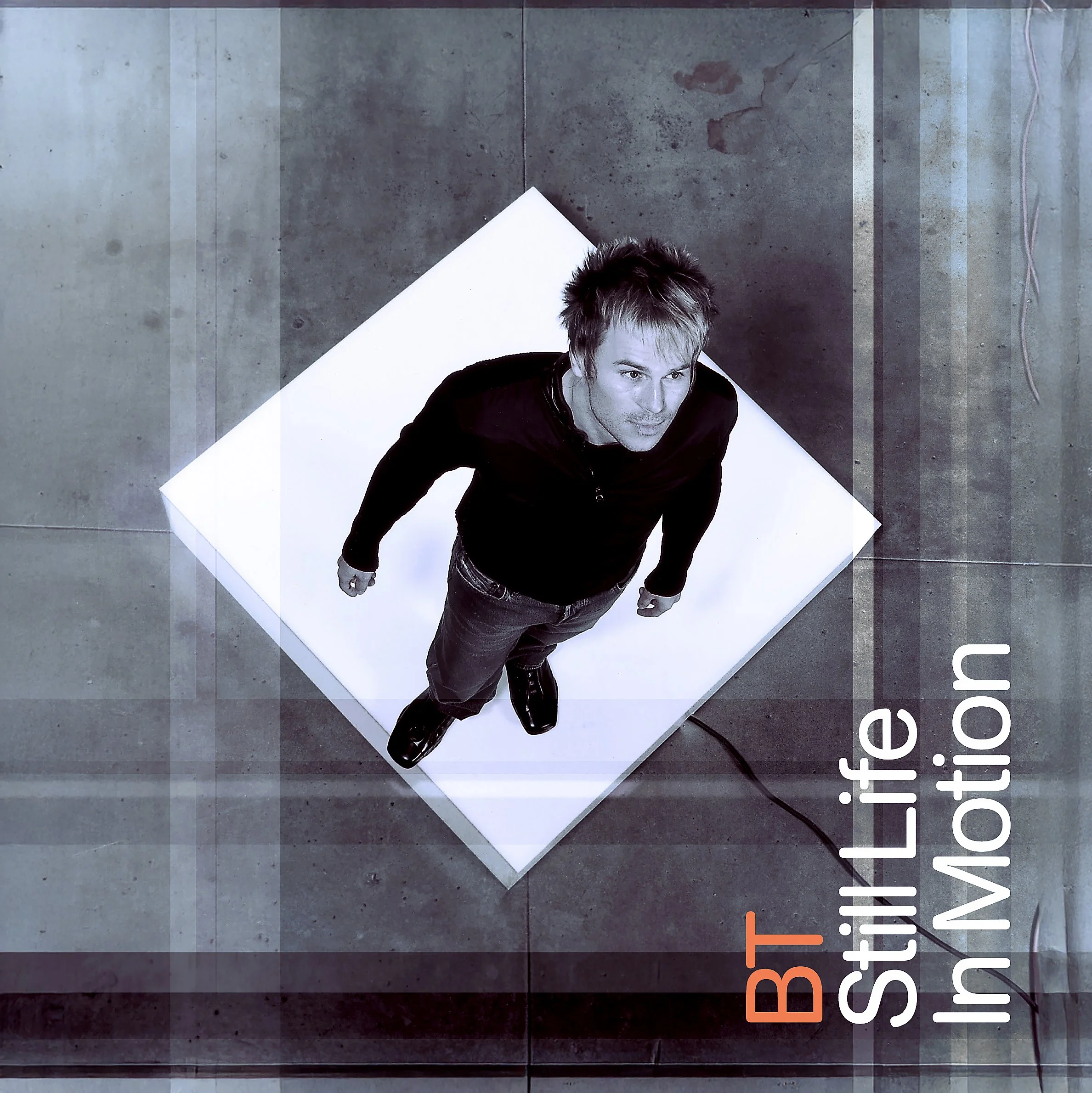 A man standing on a white platform, looking up at the camera, with the words 'BT Still Life in Motion' written in the bottom right corner.