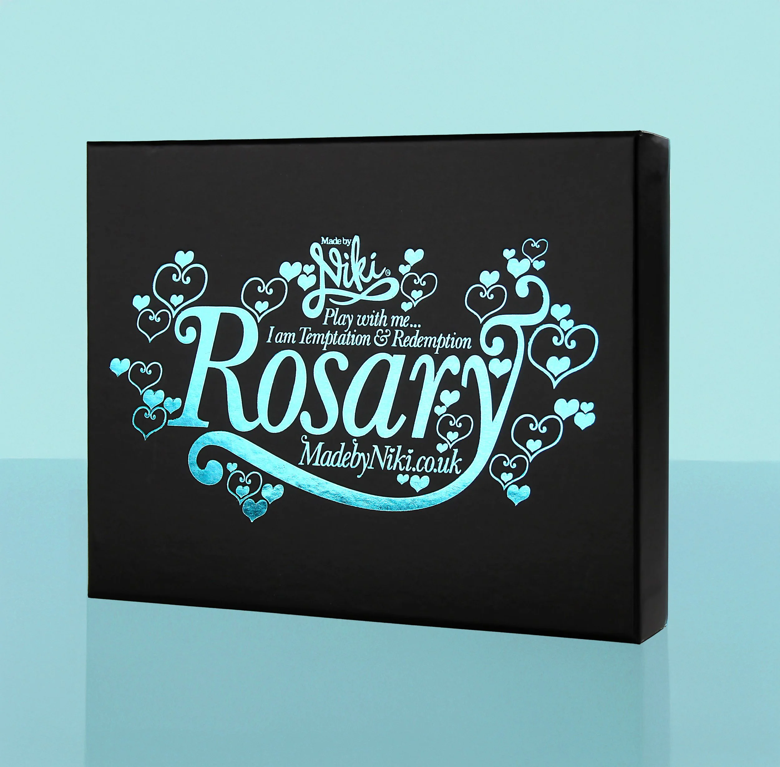 Black box with blue text and heart designs, reading "Made by Niki, Play with me... I am Temptation & Redemption, Rosary, MadebyNiki.co.uk."