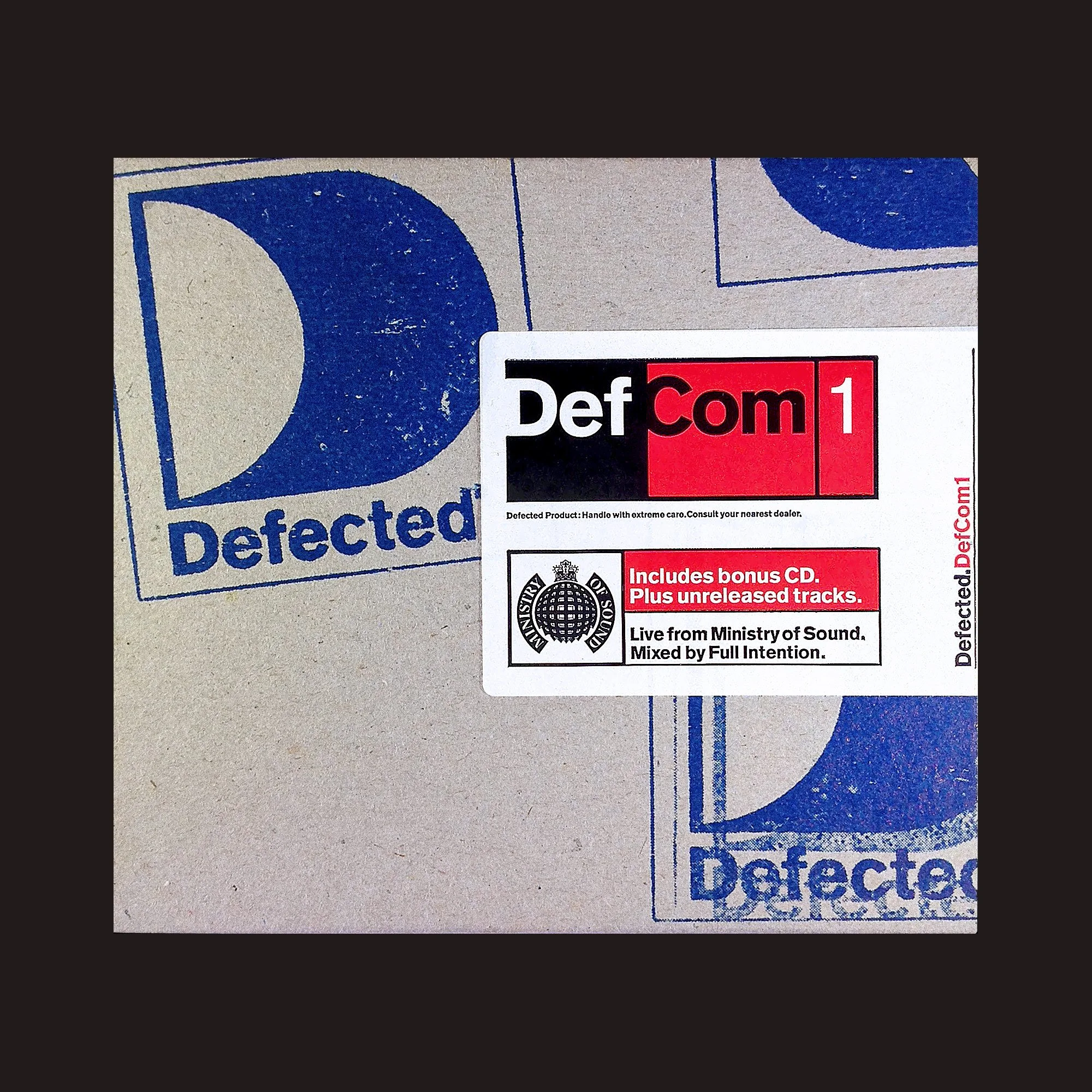 Album cover for DefCom 1, a music album with a black, red, and white design, including bonus CD information and Ministry of Sound logo, placed on a cardboard box with a blue Defected logo.