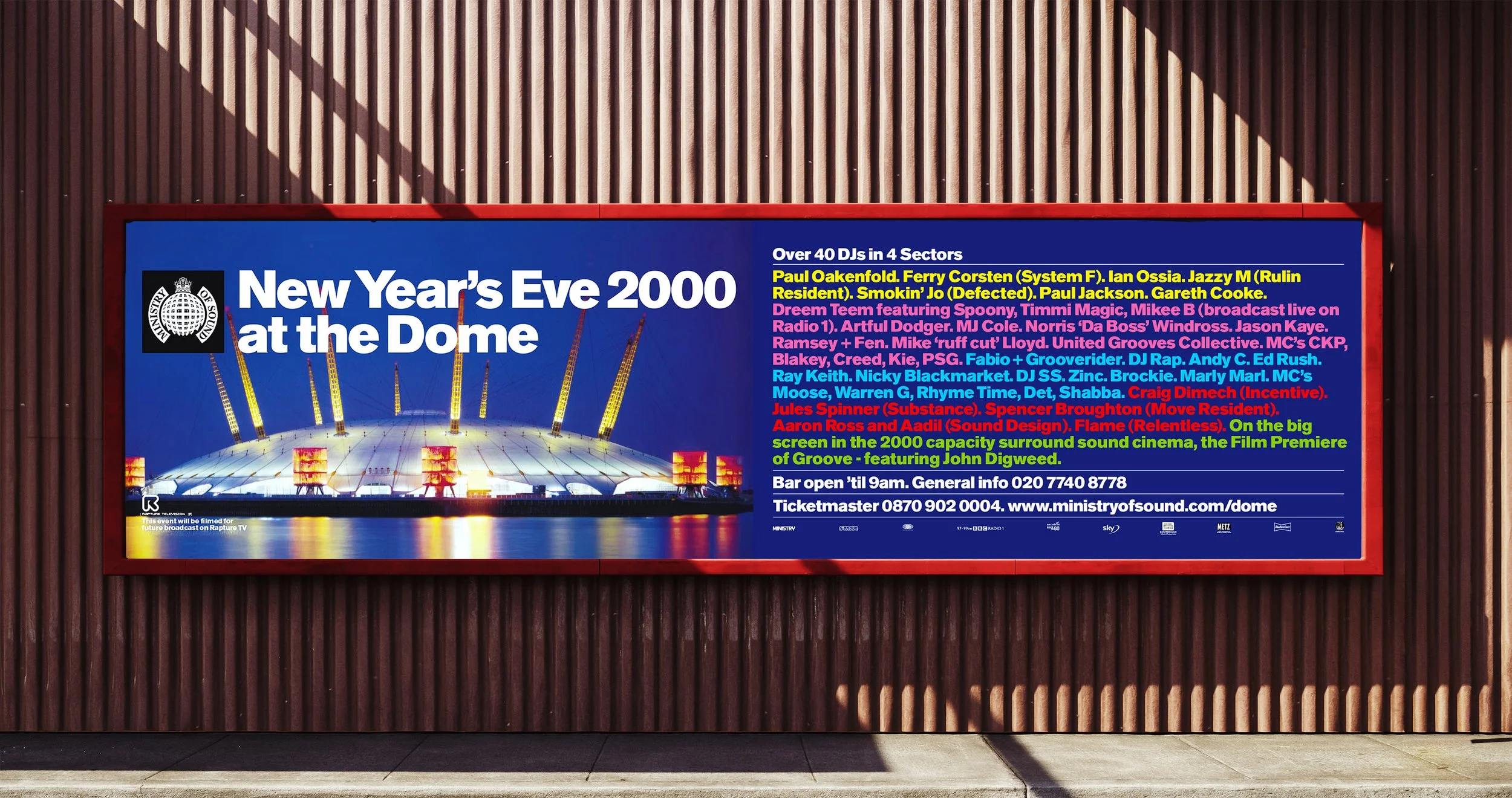 Billboard advertising a New Year's Eve 2000 event at the Dome featuring a colorful photo of the venue with bright lights and a list of performers and event details.