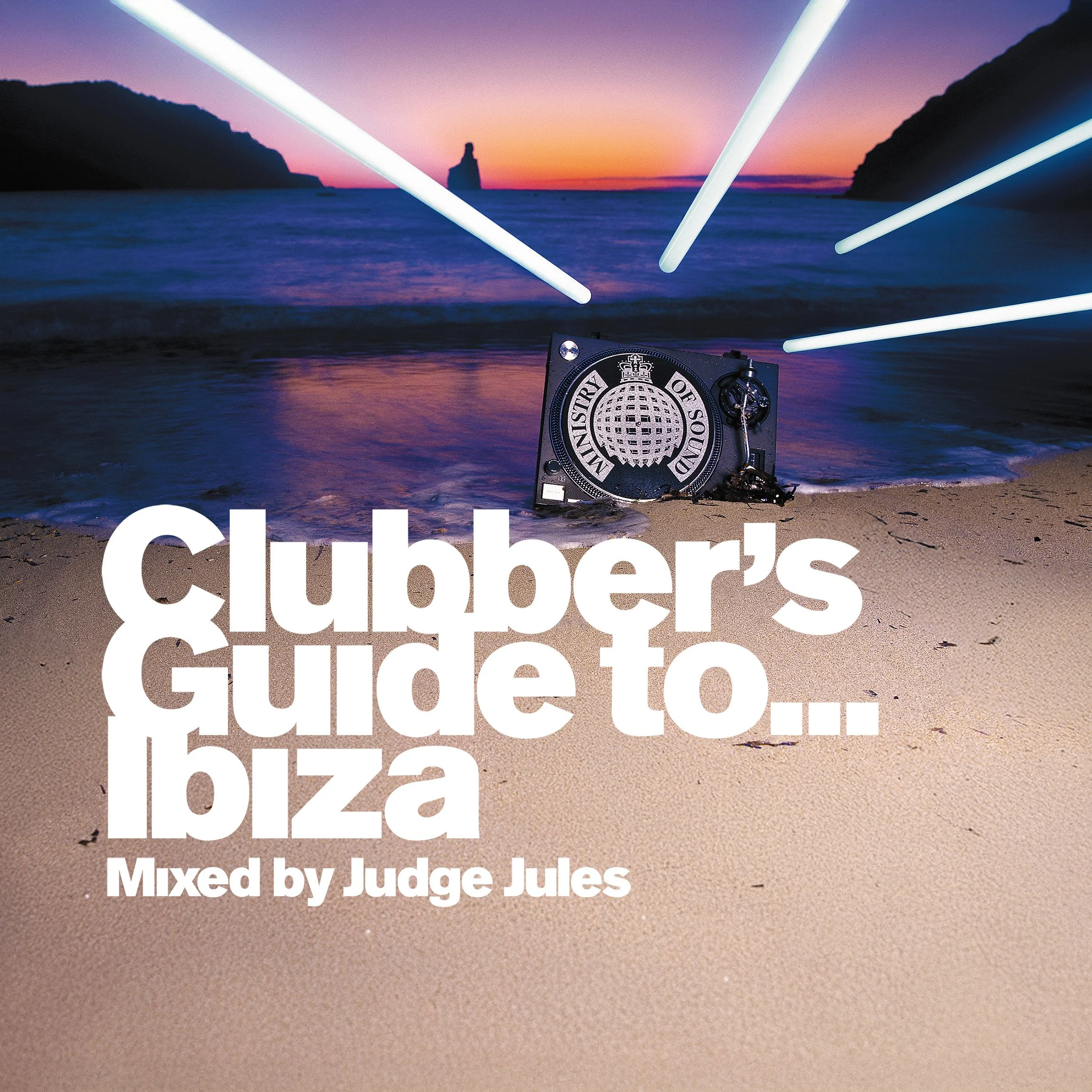 A beach scene at sunset with a DJ booth in the sand, neon lights overhead, and a large rock formation in the ocean in the background, featuring the text "Clubber's guide to Ibiza" and "Mixed by Judge Jules."