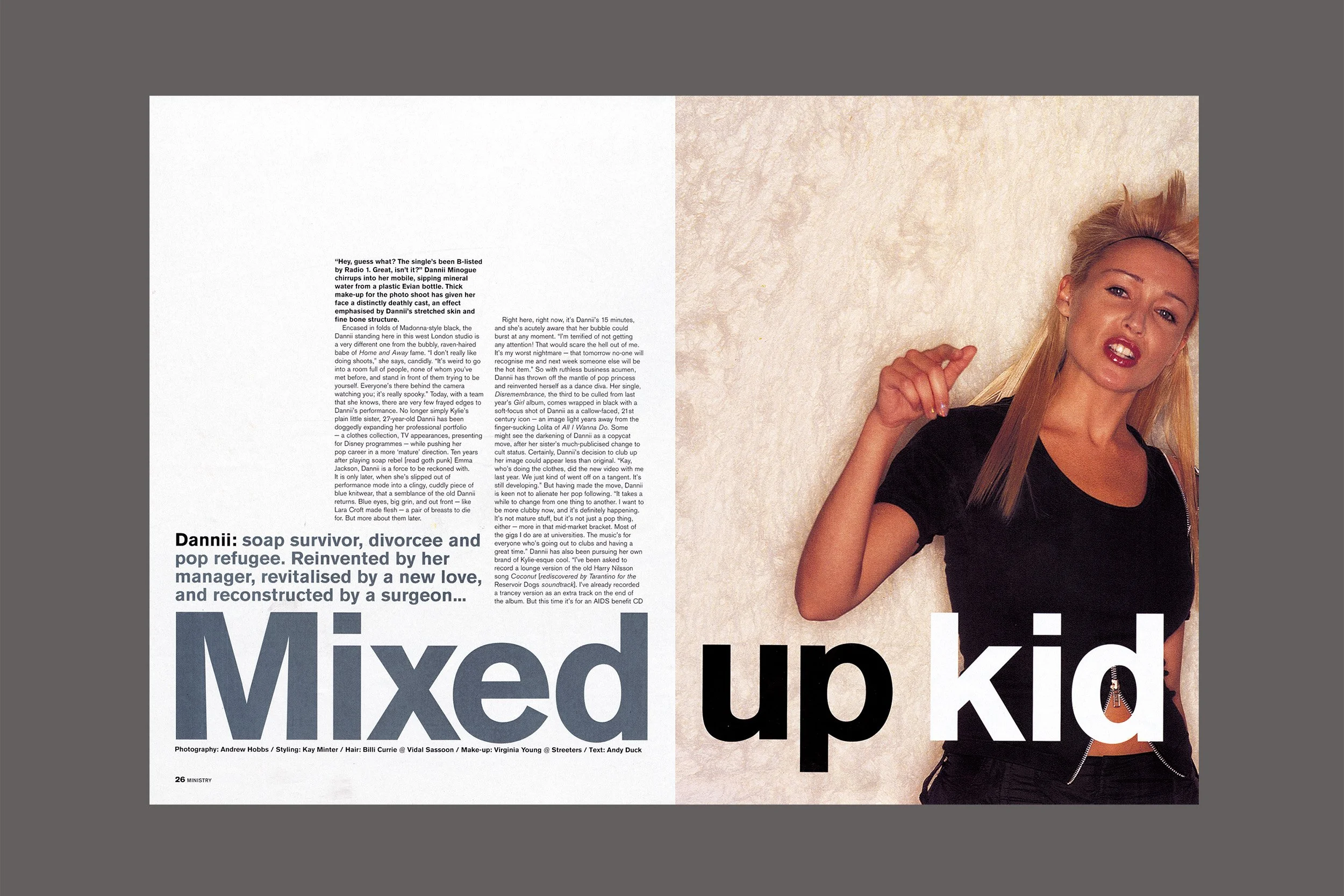 A magazine spread with a large headline that reads 'Mixed up kid' on the right side, featuring a photo of a young woman with blonde hair in a black t-shirt and zip-up jacket, making a confused or annoyed facial expression, against a beige textured background.
