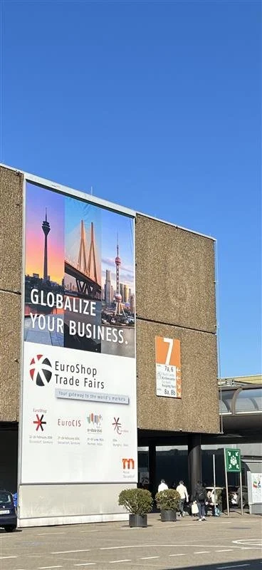 A sign at the EuroShop trade fair saying globalize your business