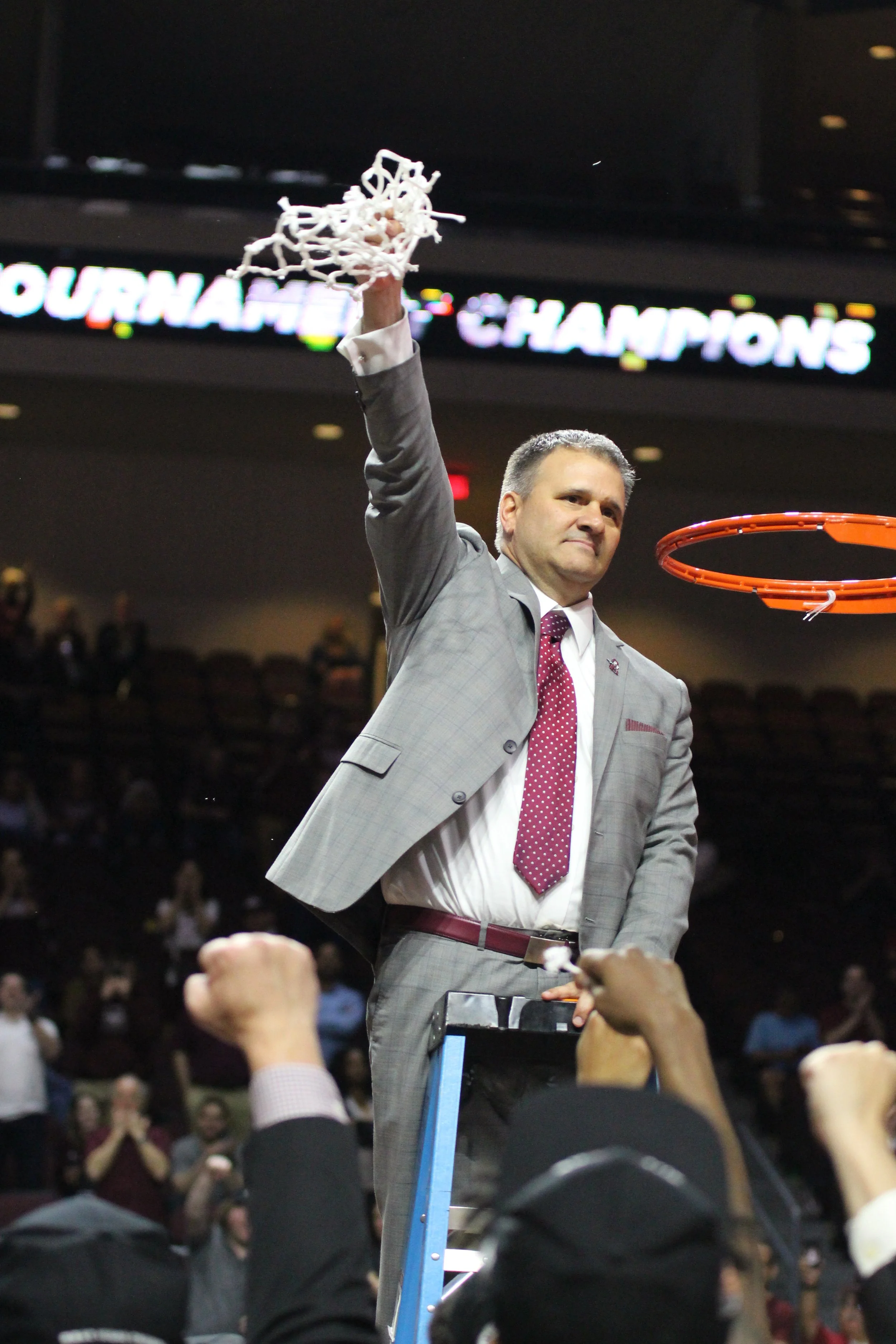 New Mexico State head coach Chris Jans holds the victory net after winning the 2019 Western Athletic Conference Tournament championship over Grand Canyon, Saturday, March 16, 2019, at Orleans Arena in Las Vegas. (Photo by Eli K. Whitney/Kokopelli)