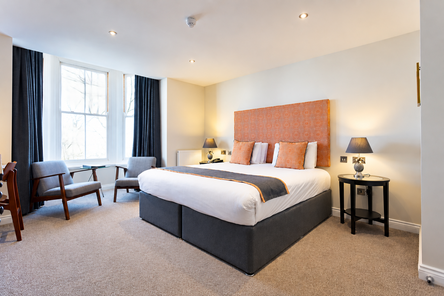 Superior ground floor hotel room at Andover House in Great Yarmouth with a large bay window, comfortable seating and decor