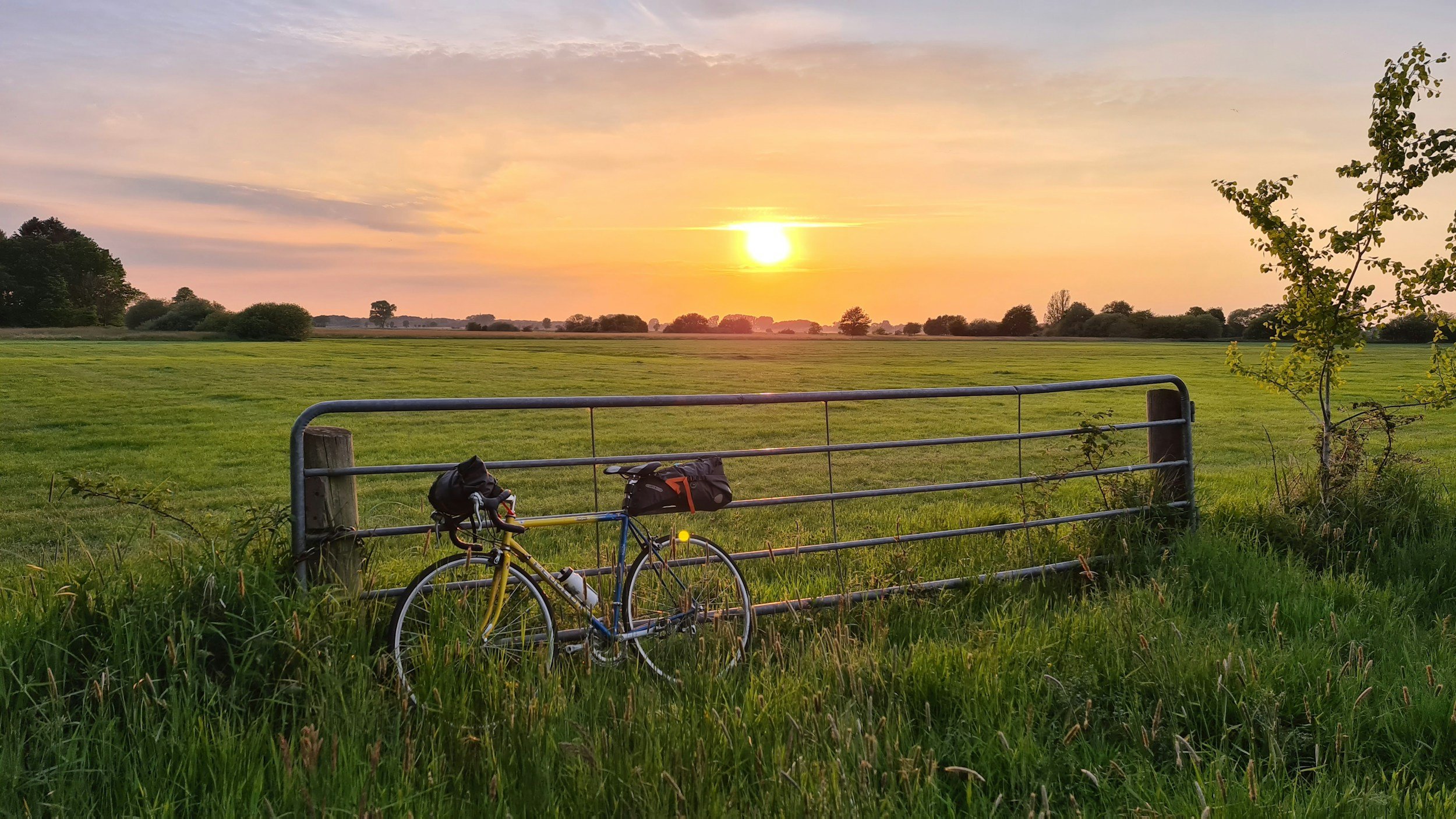 Sunset in the Norfolk countryside, bicycle against fence
