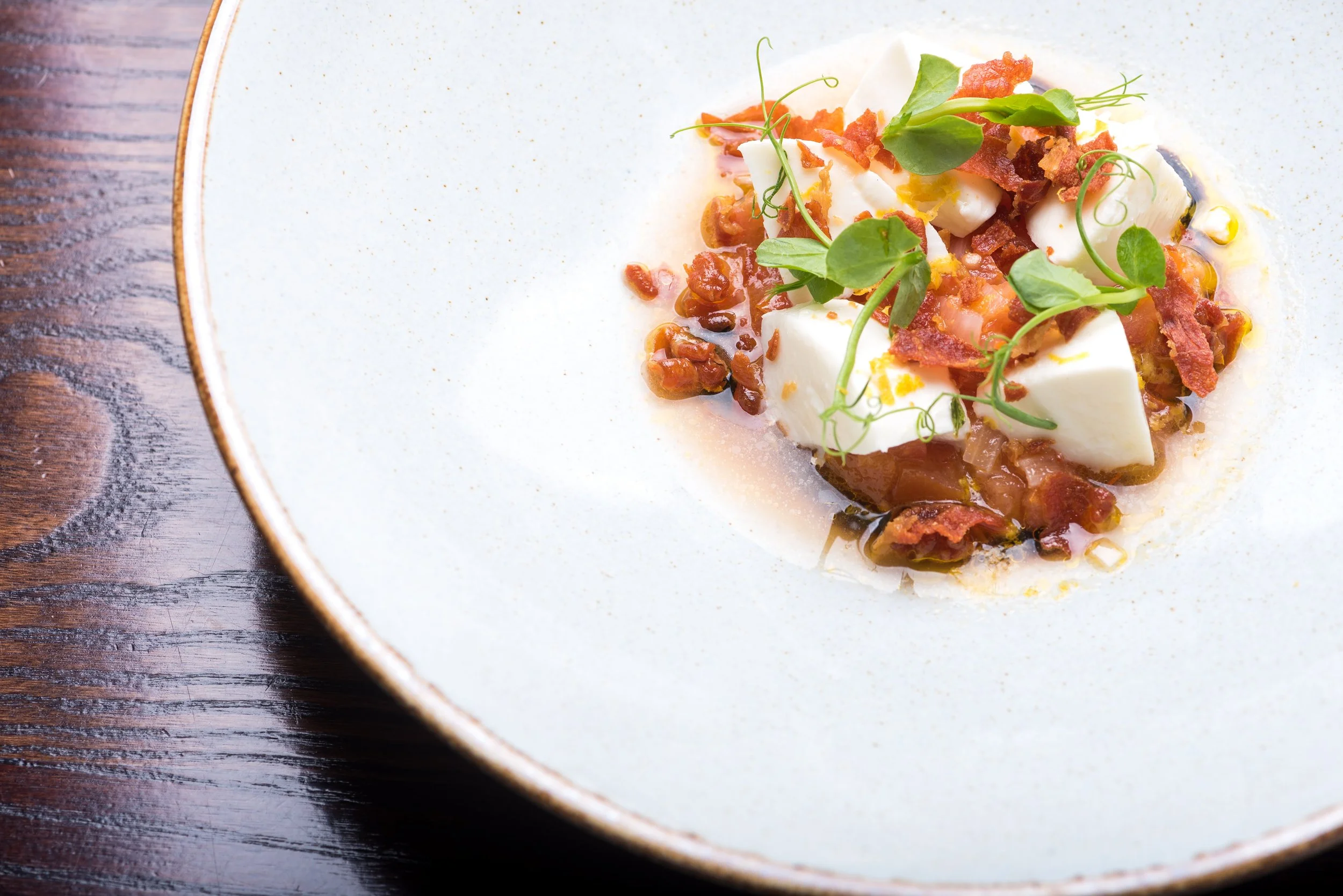 Starter dish with fresh ingredients of tomatoes and cheese served on a white plate
