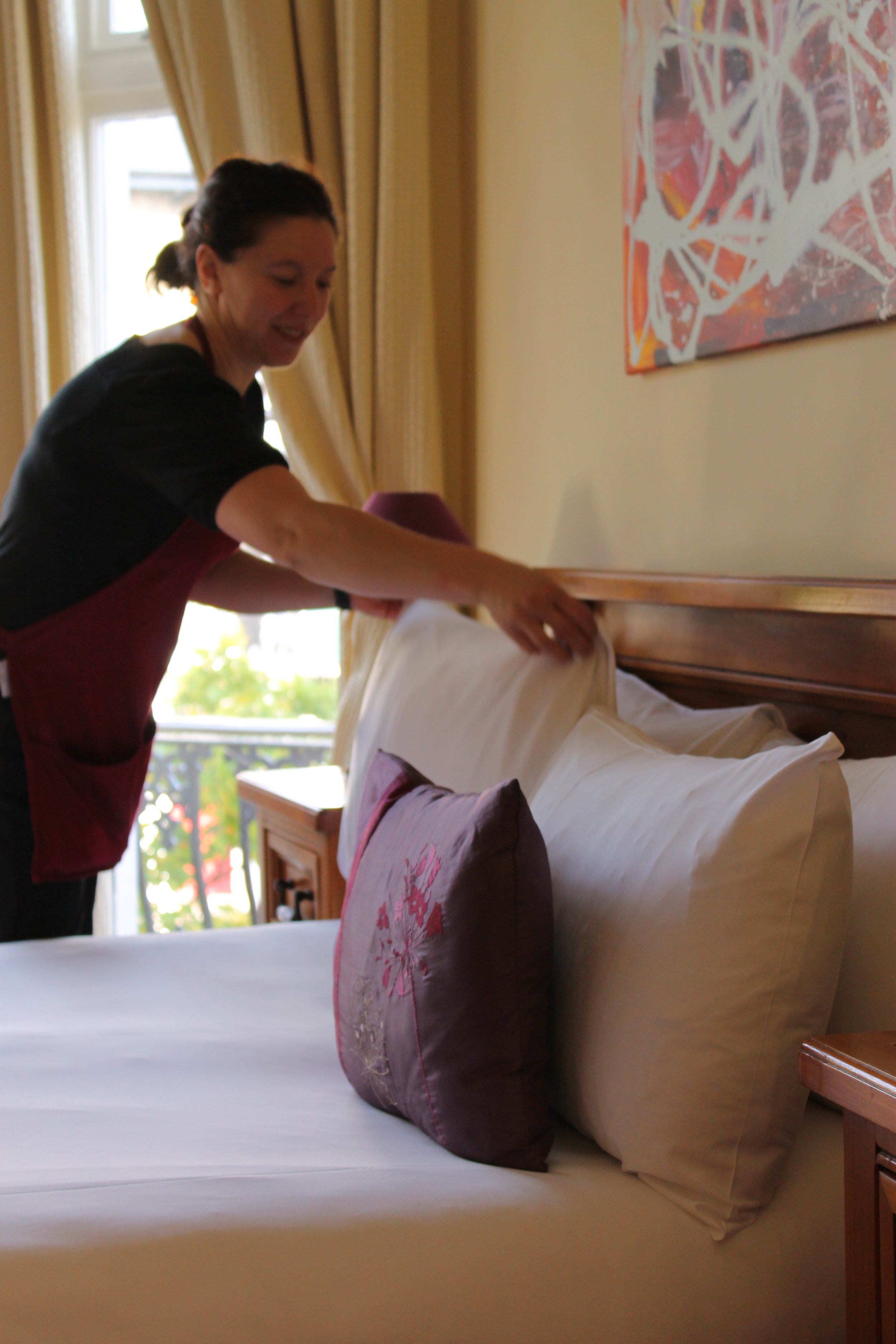 Housekeeper tidying hotel bedrooms at Andover House Hotel in Great Yarmouth