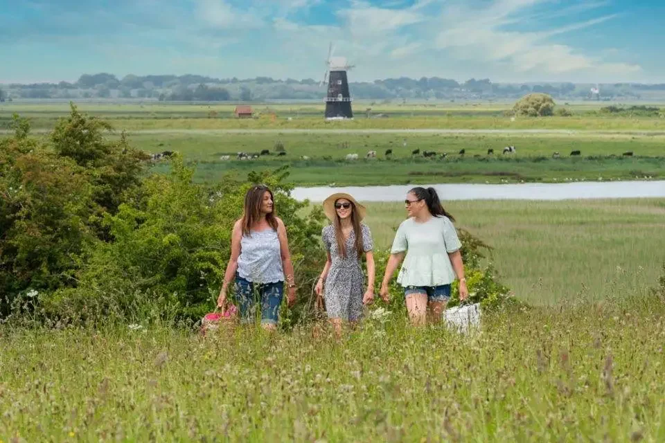 Ladies walking through the fields near Great Yarmouth in Norfolk