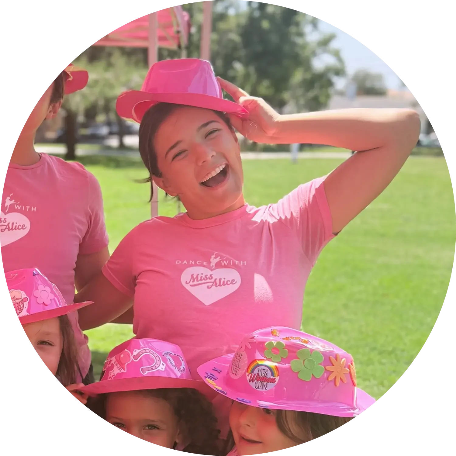 Portrait of Miss Ema, wearing a Dance with Miss Alice pink shirt.