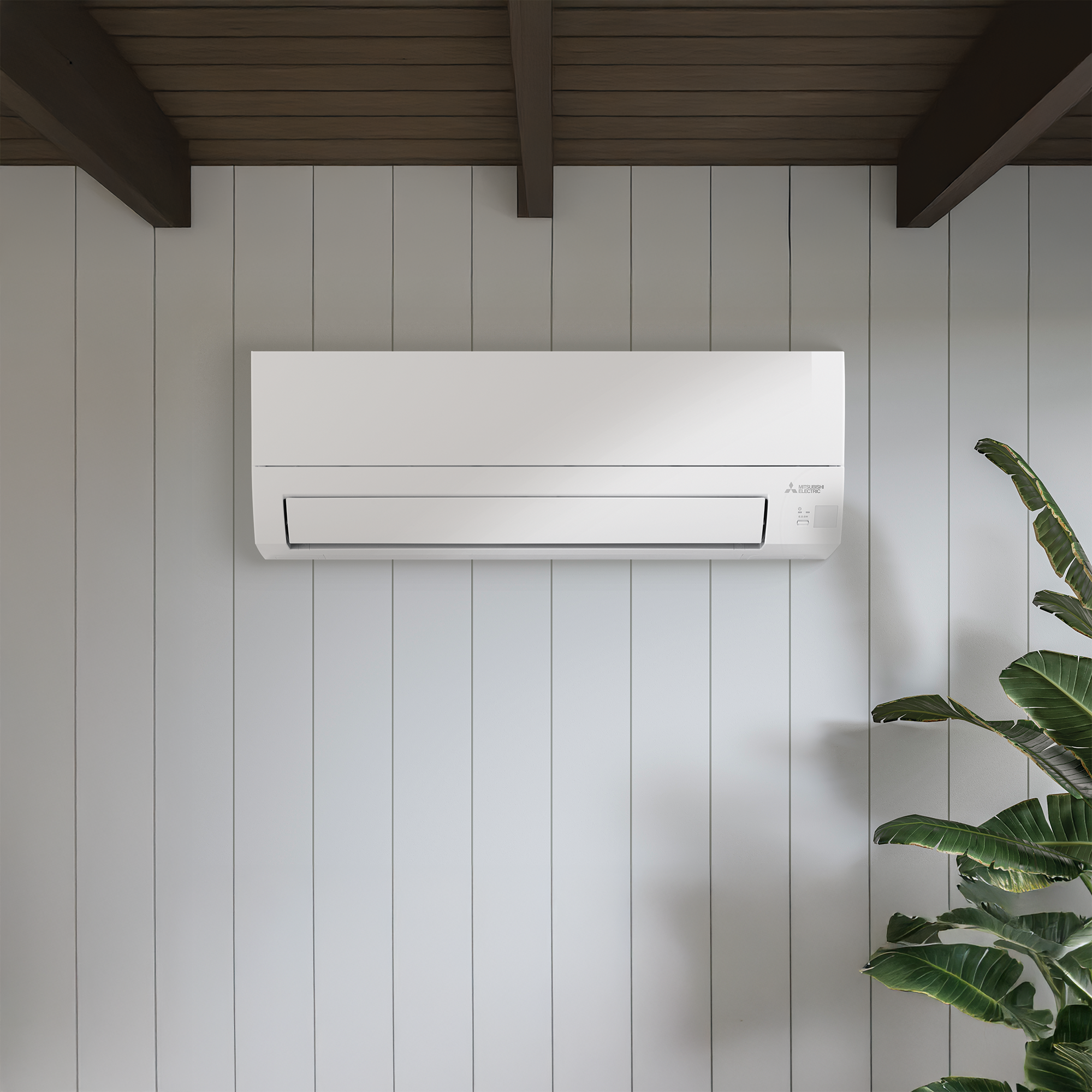 Wall-mounted white Mitsubishi air conditioner unit on a light gray paneled wall in a room with wooden ceiling.