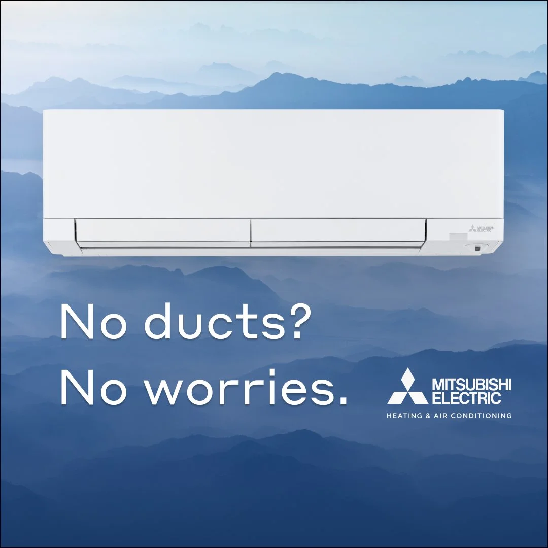 An advertisement for Mitsubishi Electric heating and air conditioning featuring a white air conditioner unit against a blue mountain landscape background with the text 'No ducts? No worries.'