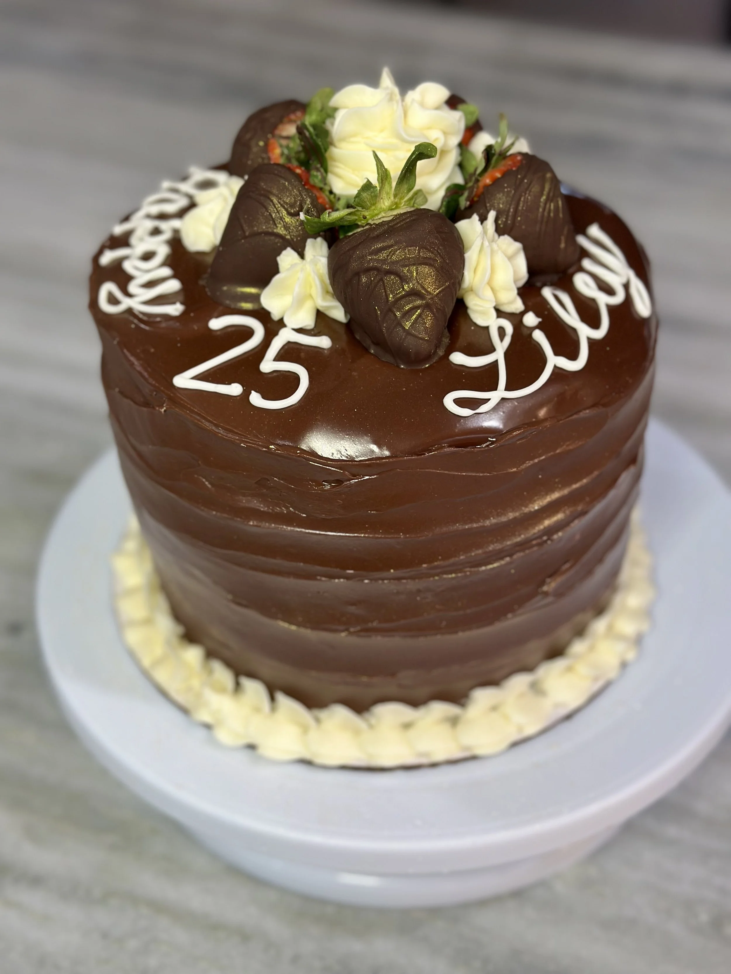 Chocolate cake with strawberries and cream filling and chocolate ganache glaze