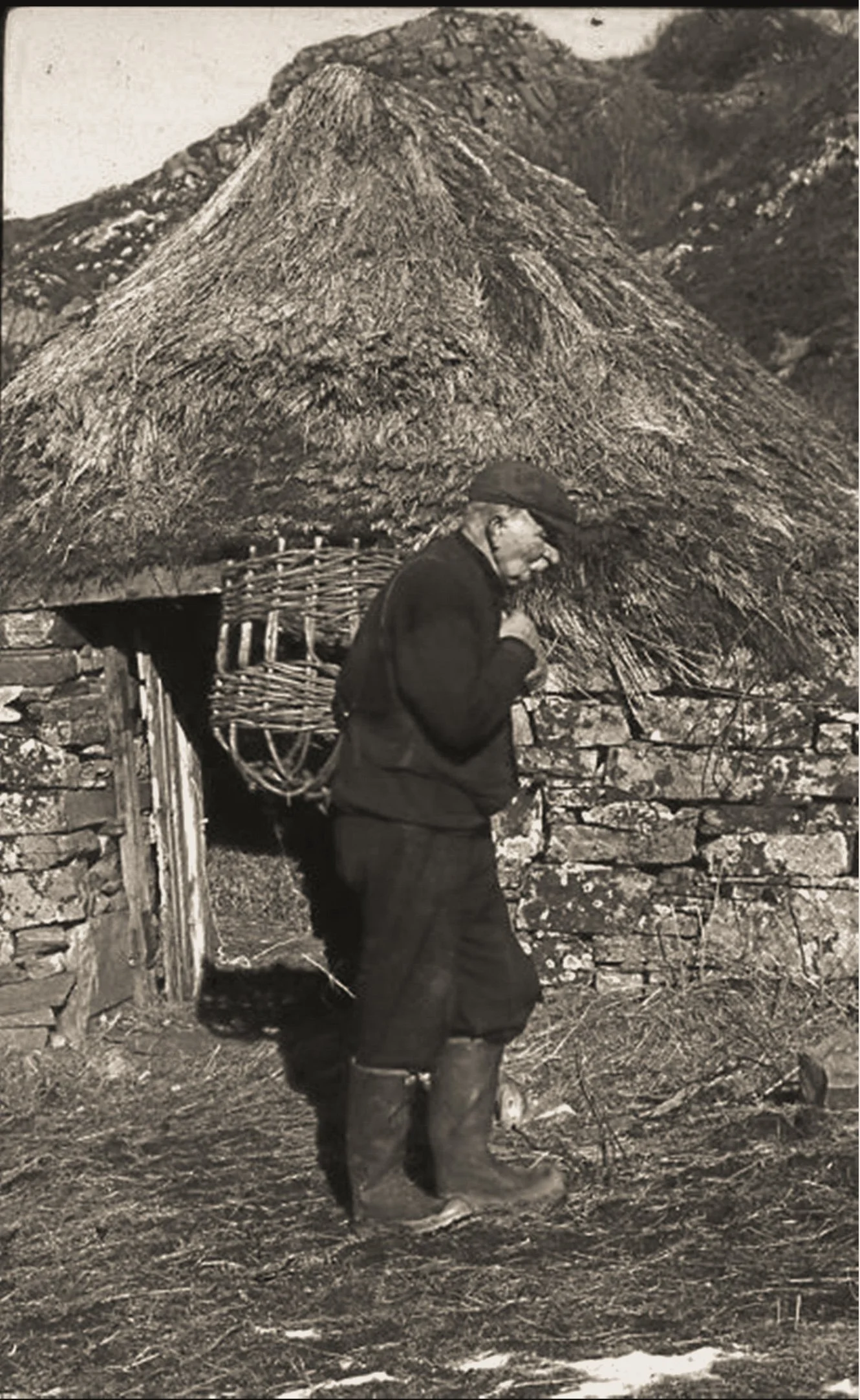 Blackhouse Rum, BH monogram logo, Off Grid distillery, Glenuig, Moidart, Craft rum, Scottish Rum, Craft Spirit, Small batch RumAngus MacNeil carrying a creel, photographed by Eric Meadows, Smirisary Moidart late 1950's