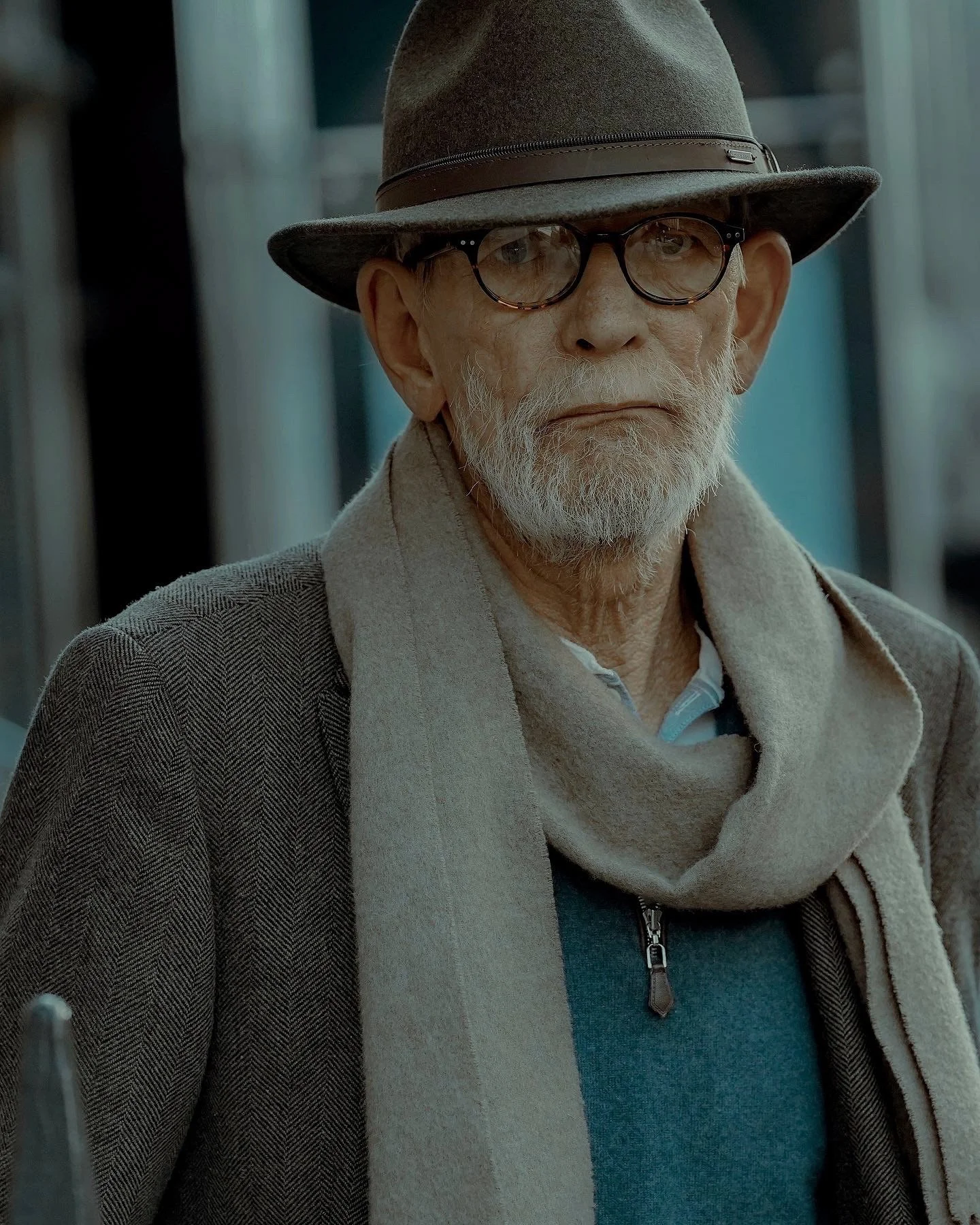 Candit Dublin street portrait of an older man in a brown hat and scarf , wearing glasses- photo by Daniya.