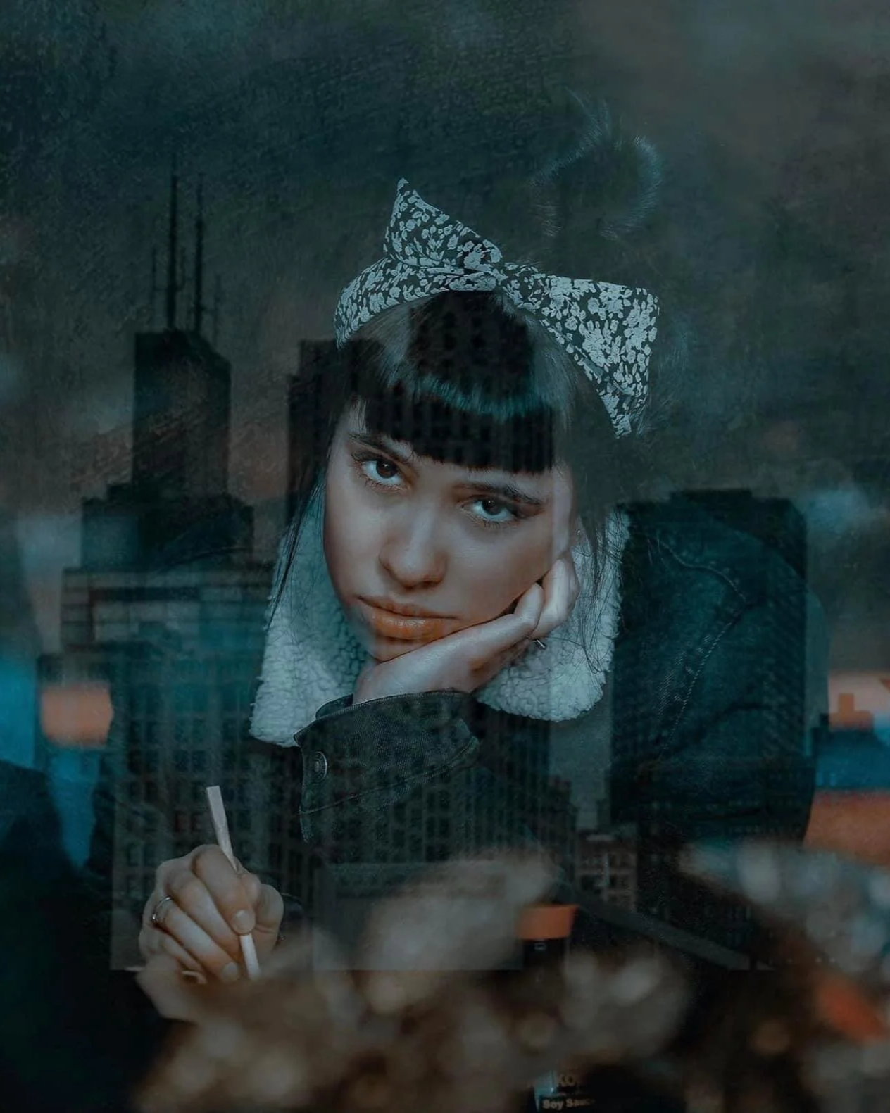Moody Dublin portrait of a young woman with a bow headband, gazing through a window reflection – Photo by Daniya, street photography.
