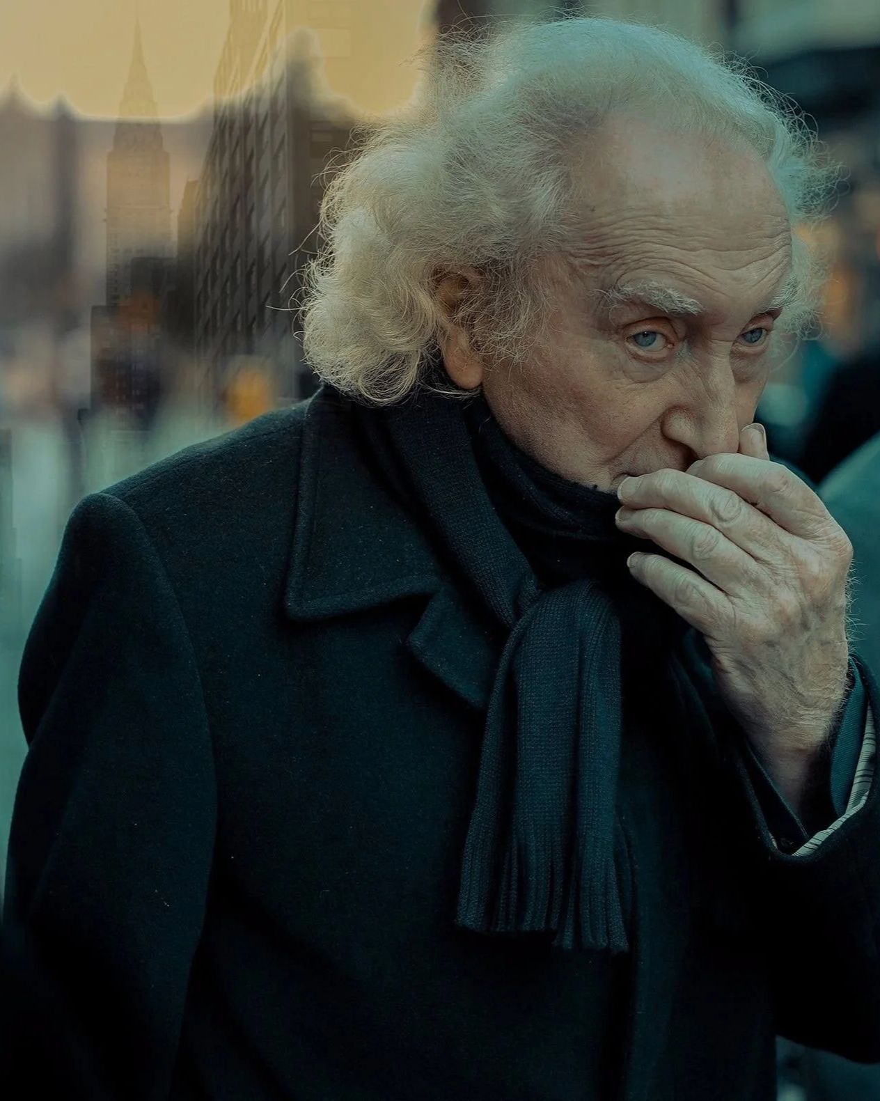 Older man with curly hair and black scarf, captured in a reflective moment — Dublin street photography, Photo by Daniya.