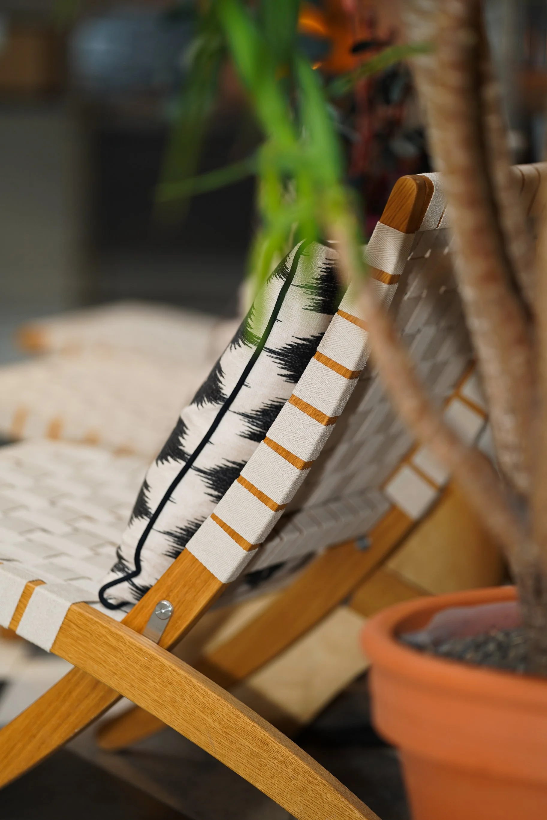 Detail of cozy café chairs with patterned pillows.