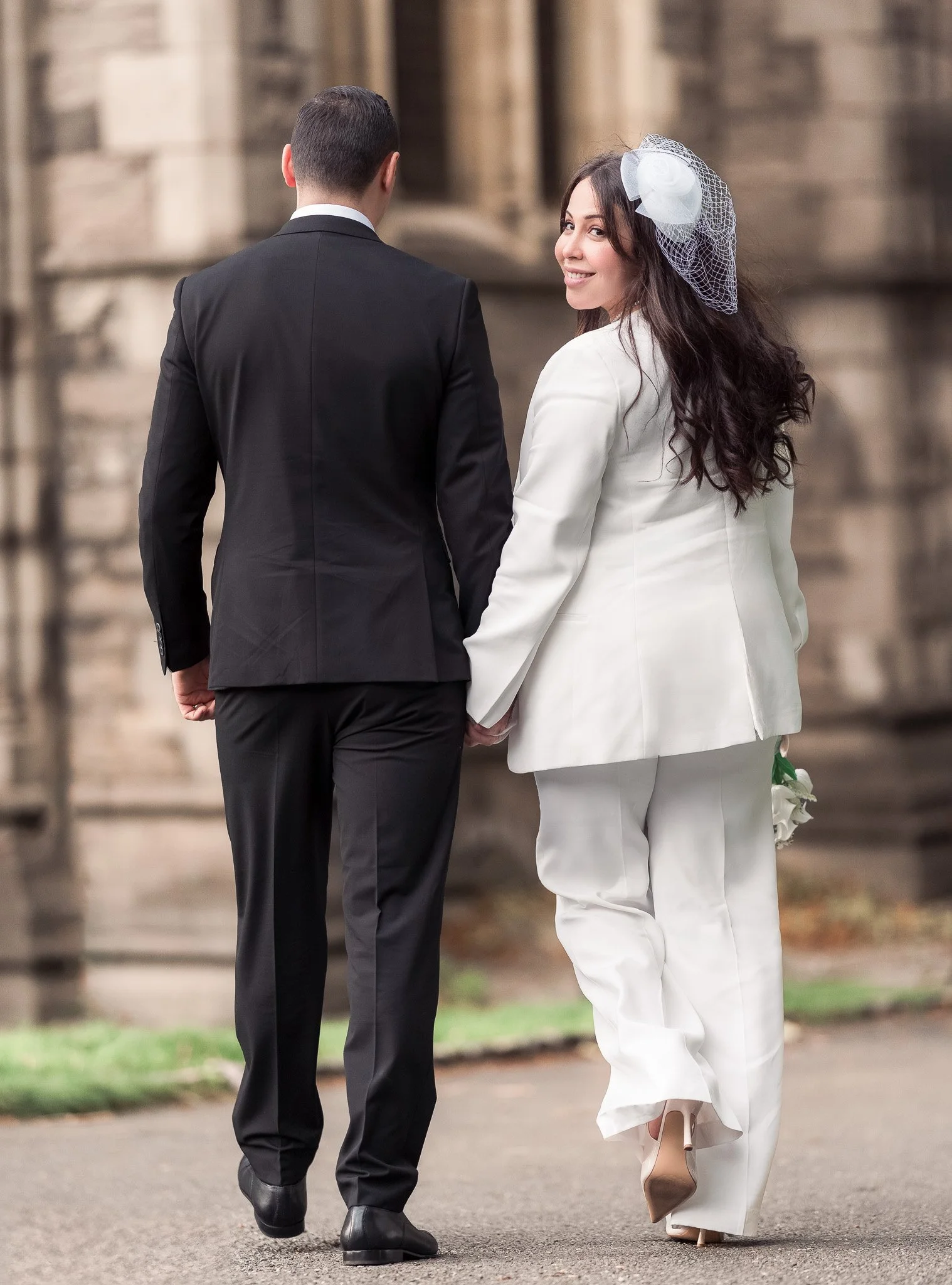 Bride and groom walking away together, symbolizing the beginning of their journey.