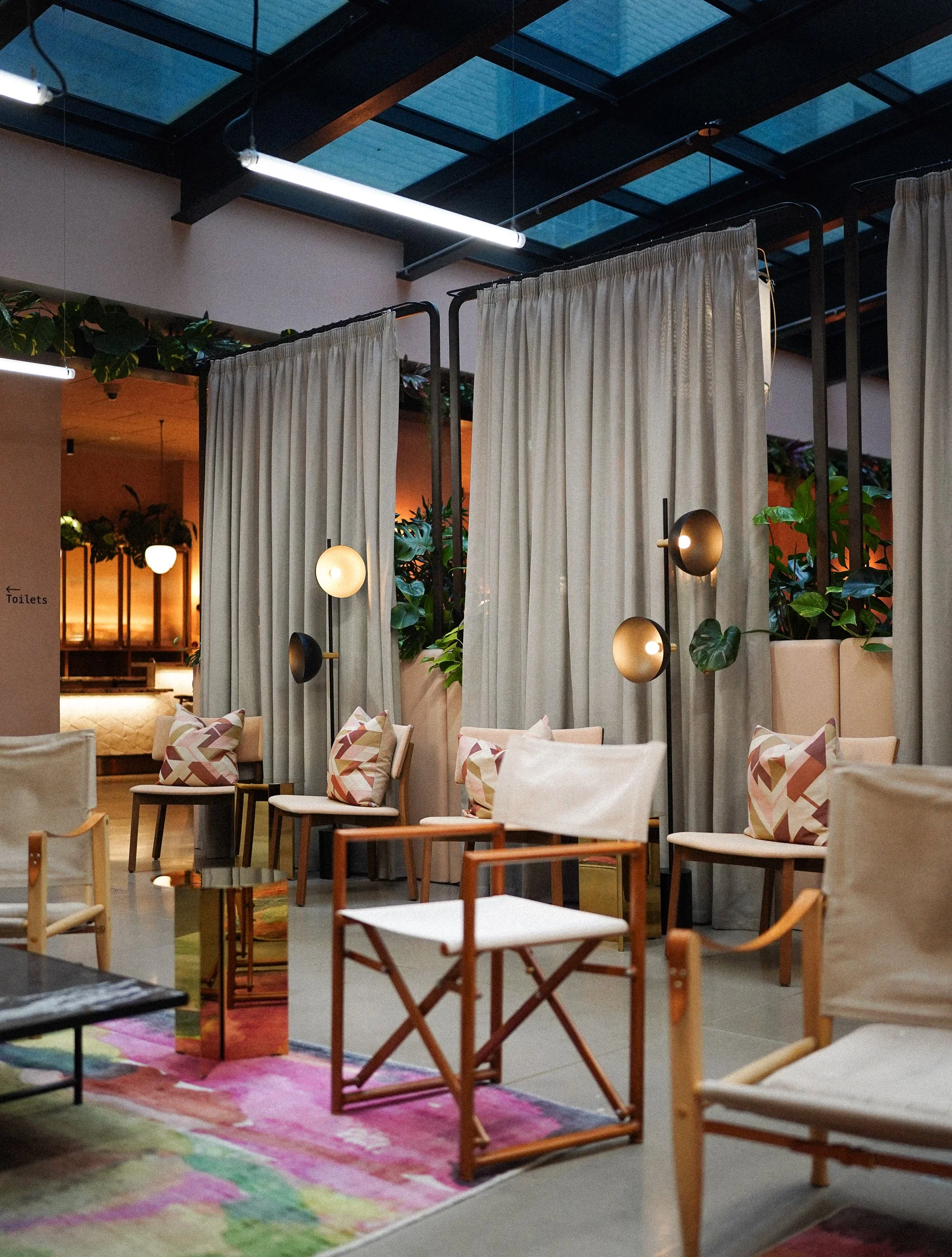 Stylish café interior with modern chairs and warm lighting.