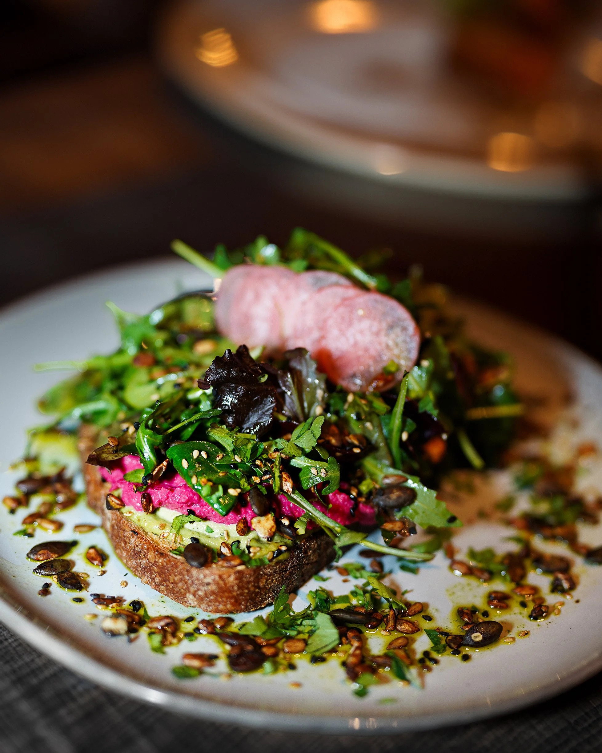 Close-up of fresh avocado toast with salad and radish in Dublin café.