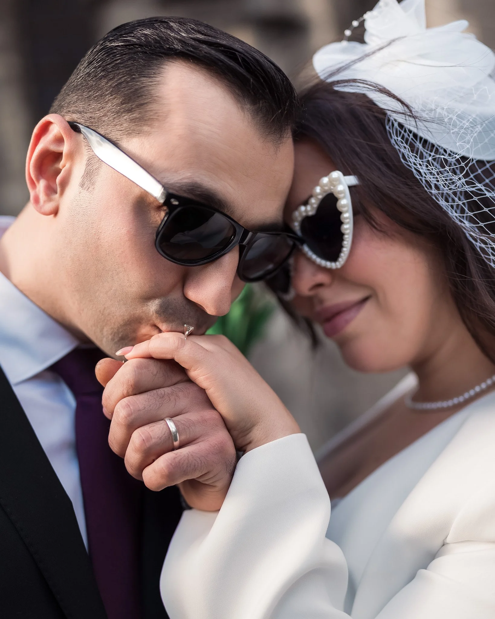 Romantic close-up — groom kissing his bride’s hand, showing true affection and elegance.