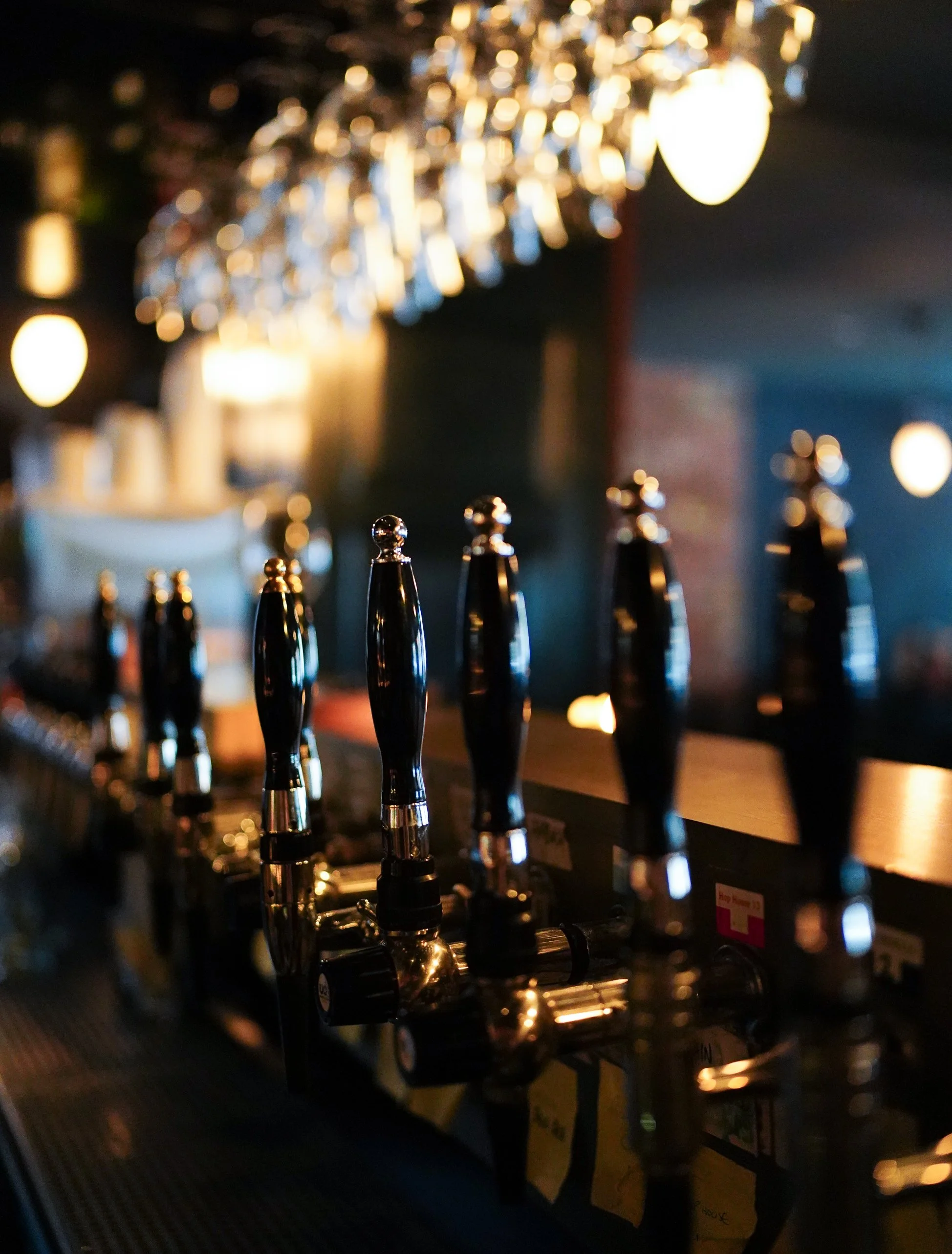 Bar counter with elegant lighting and bottles in Dublin café.