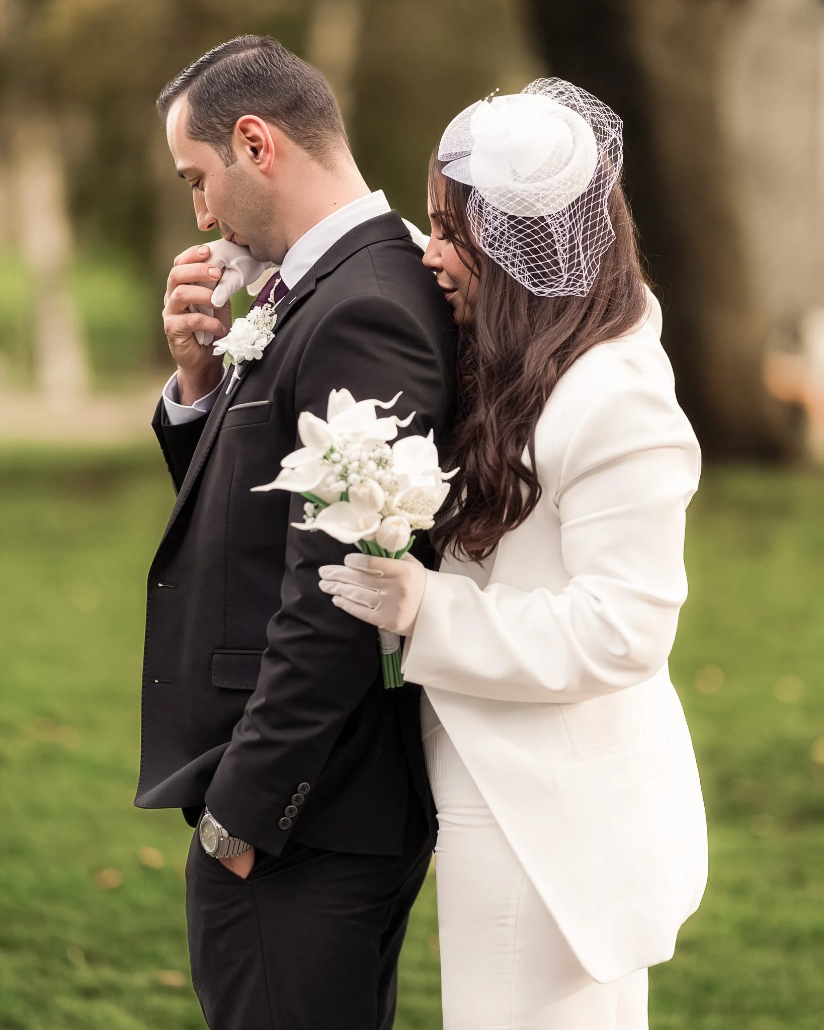 Emotional moment — groom holding his bride’s bouquet, full of tenderness and love.