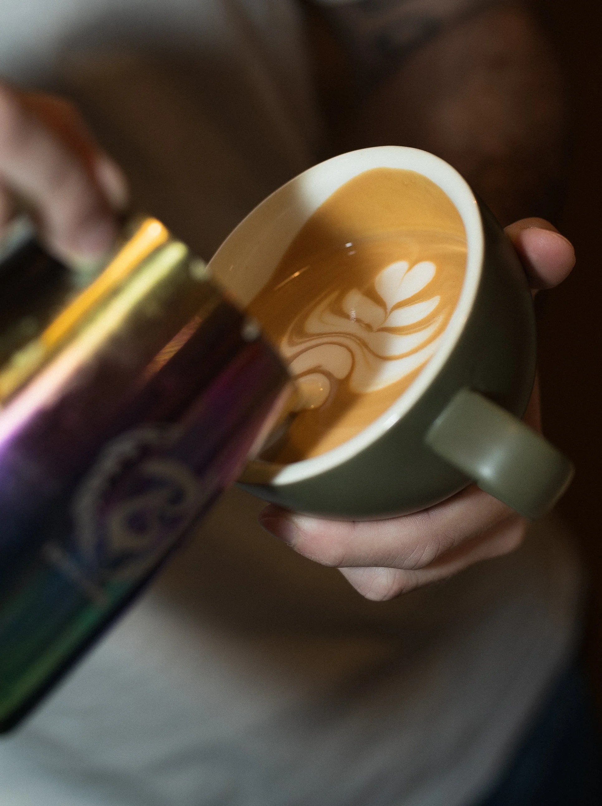 Barista pouring latte art in Dublin café, coffee photography.