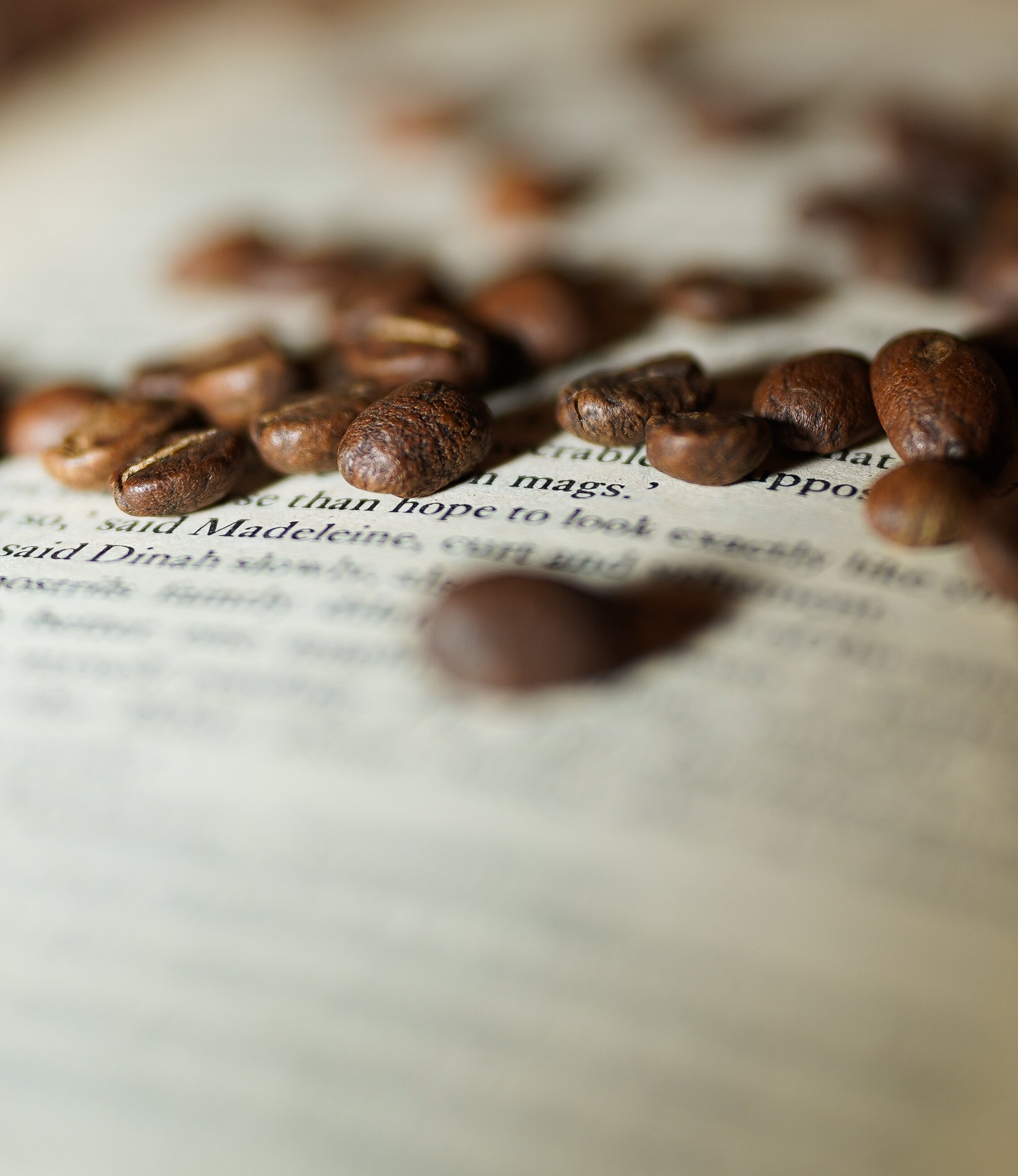 Coffee beans scattered on a vintage paper background.