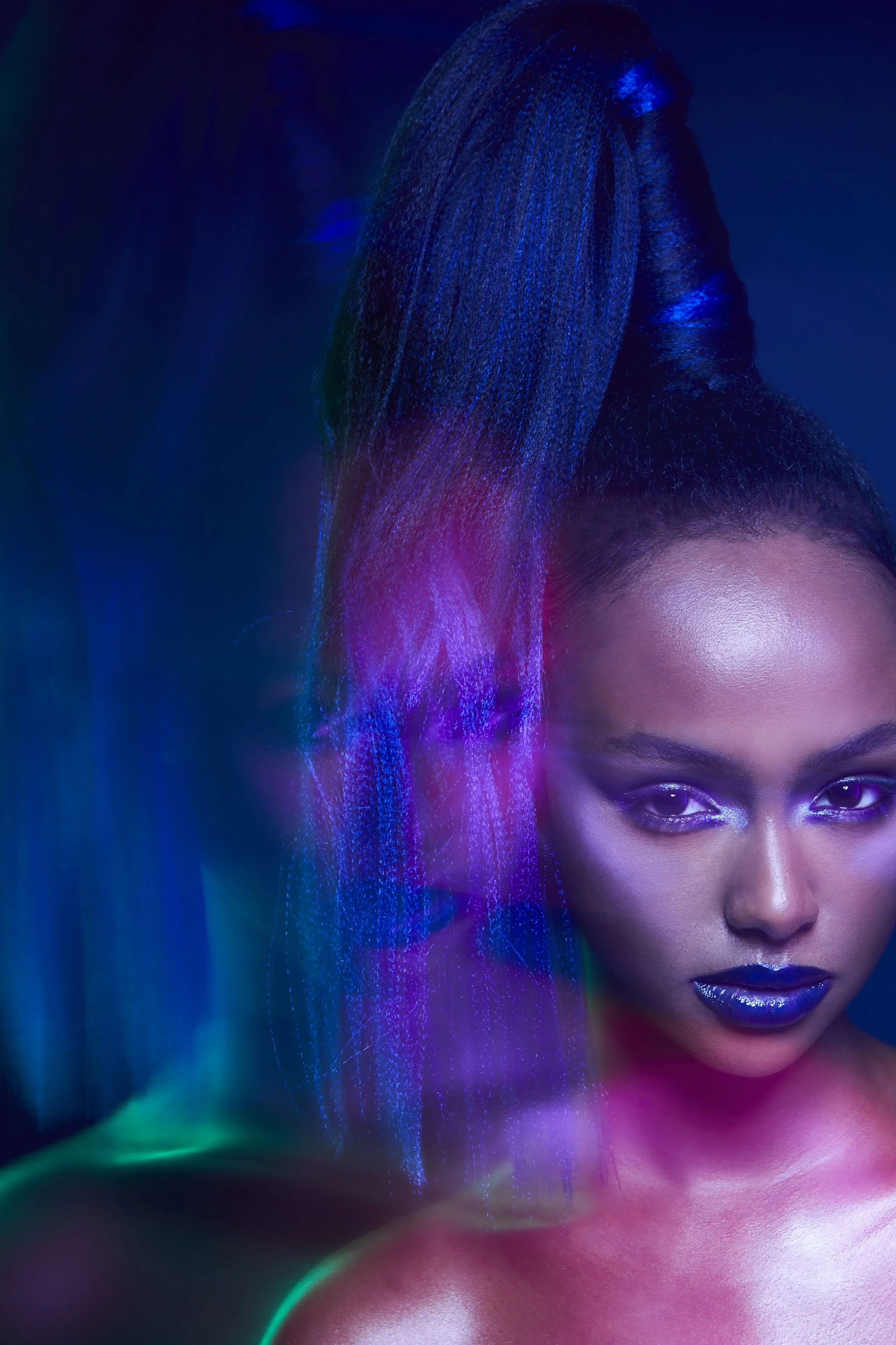 A cropped beauty image of a female model with blue lipstick  and duplicate image imposed