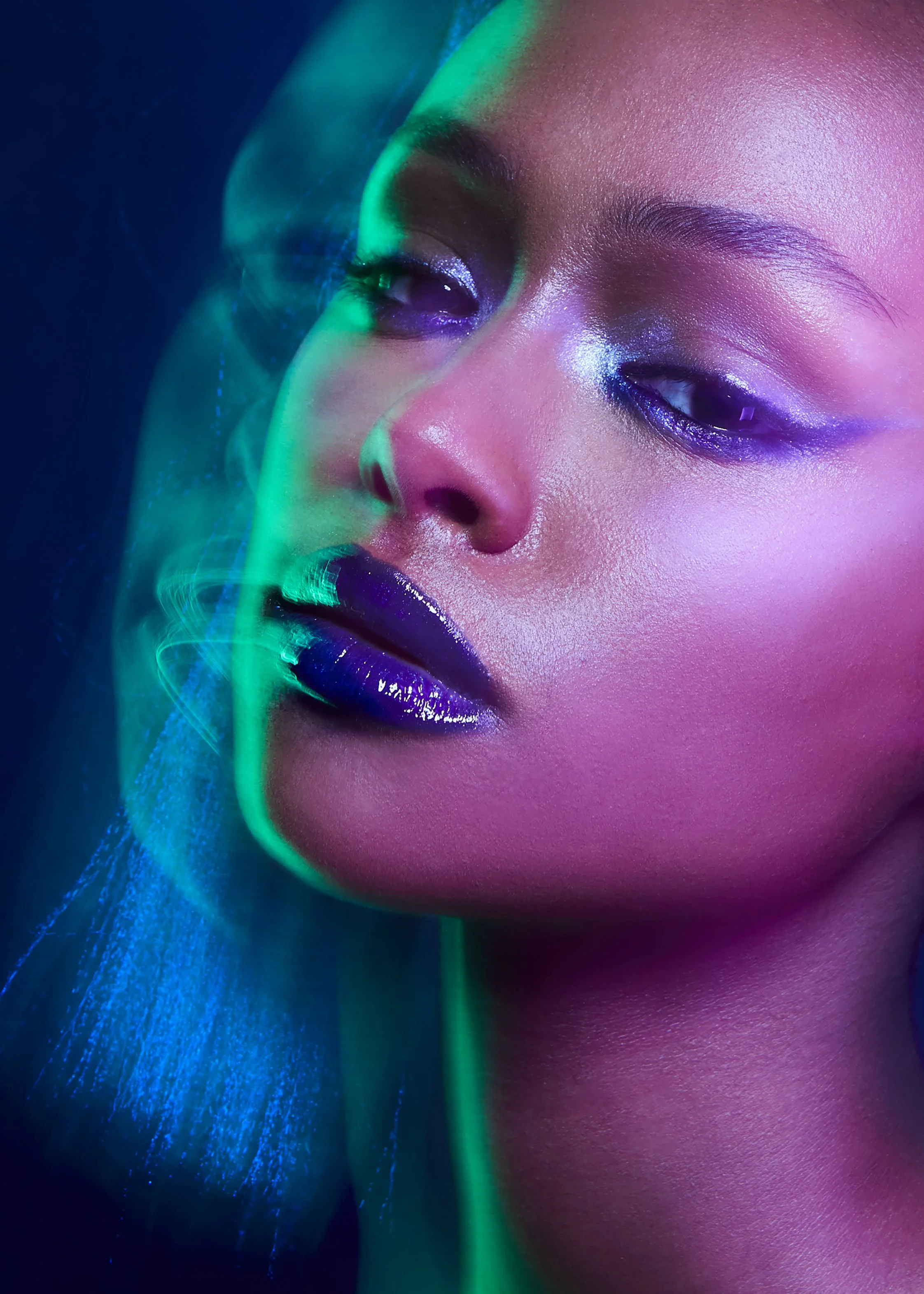 A cropped beauty image of a female model with blue lipstick  and light trails