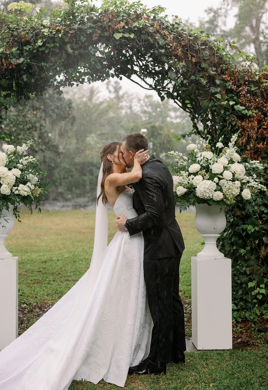 Laurie’s customers, Fernando and Kate embracing by the lake on their wedding day.