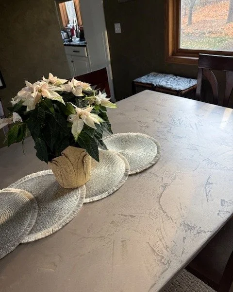 From worn tabletop to custom metal finish.

I decided to upgrade our dining table into something both durable and beautiful. This started as an inexpensive wooden surface that wore down fast. Years of shared meals and games left it covered in water s
